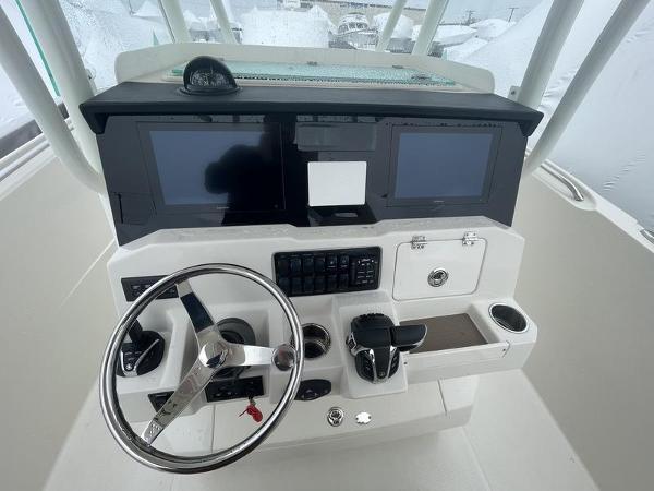 2023 Sailfish 290 CC boat dashboard with steering wheel and dual screens.
