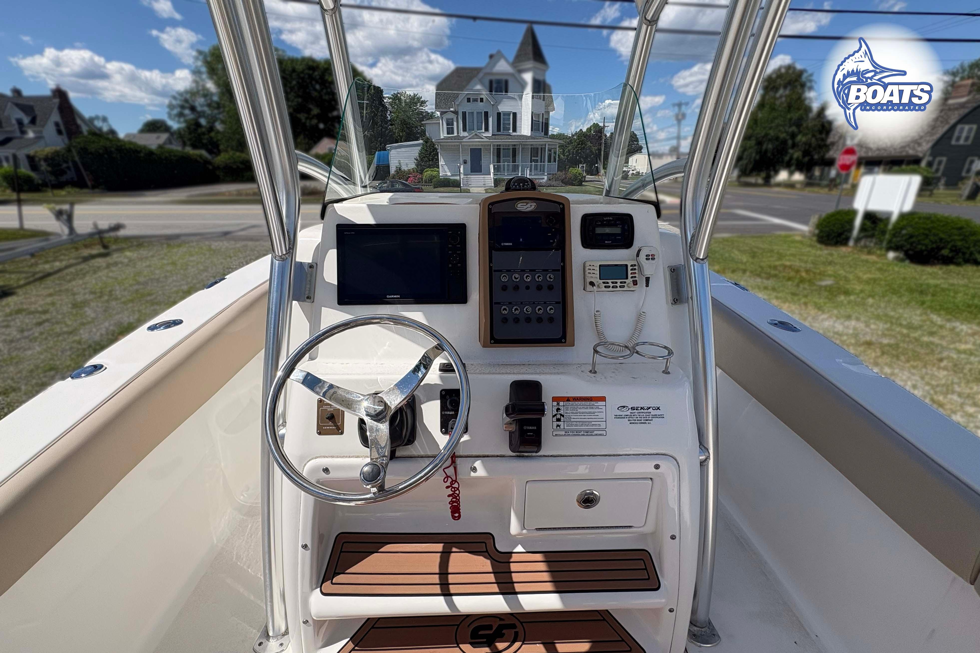 2015 Sea Fox 266 Commander boat console with steering wheel and navigation equipment.