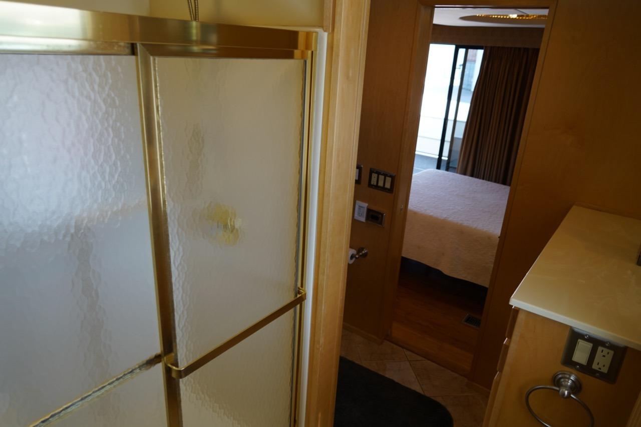 Bathroom and bedroom interior of a 2000 Stardust Cruisers 83'x17' houseboat.