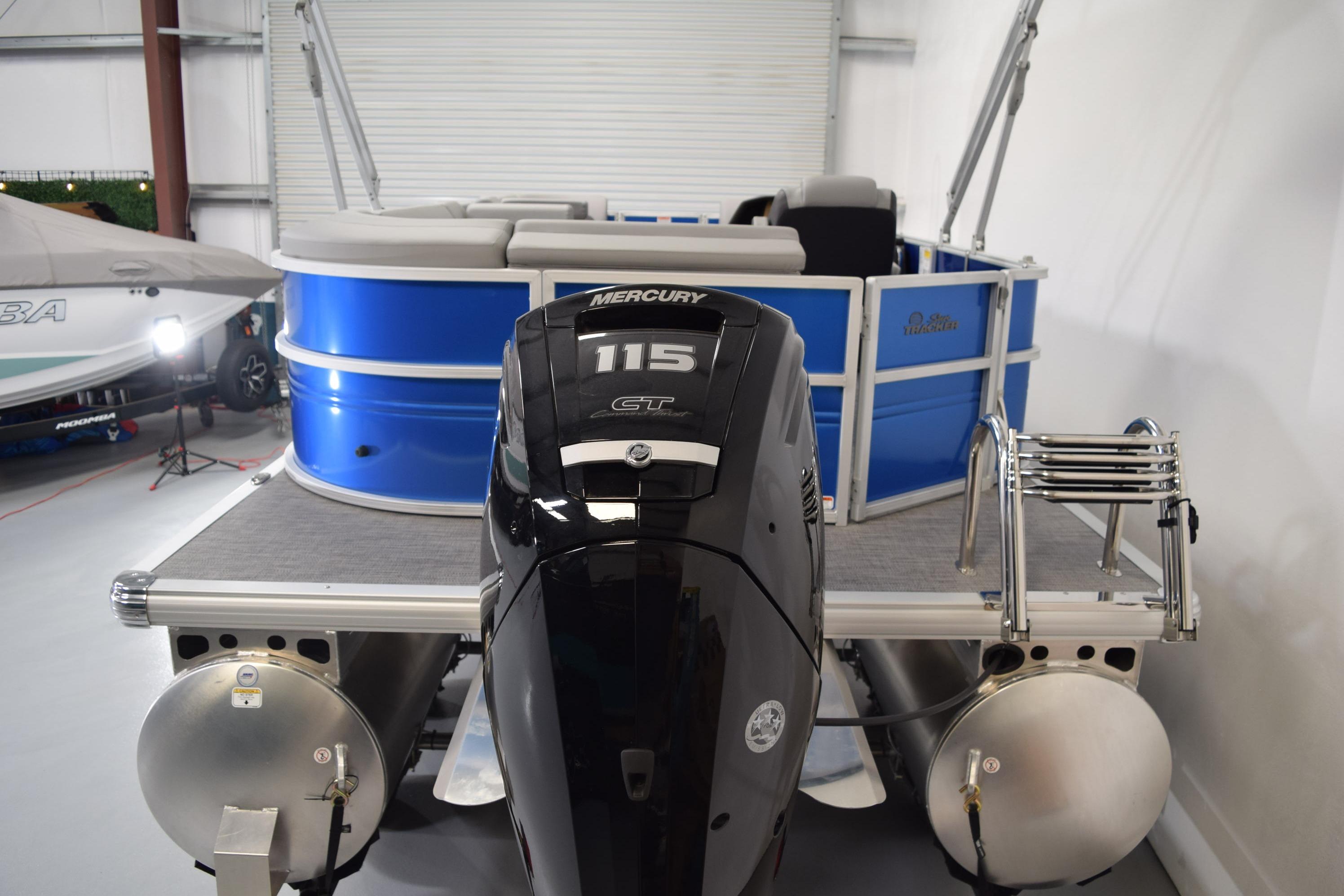 2026 Sun Tracker Party Barge 20 DLX with Mercury 115 engine in showroom.