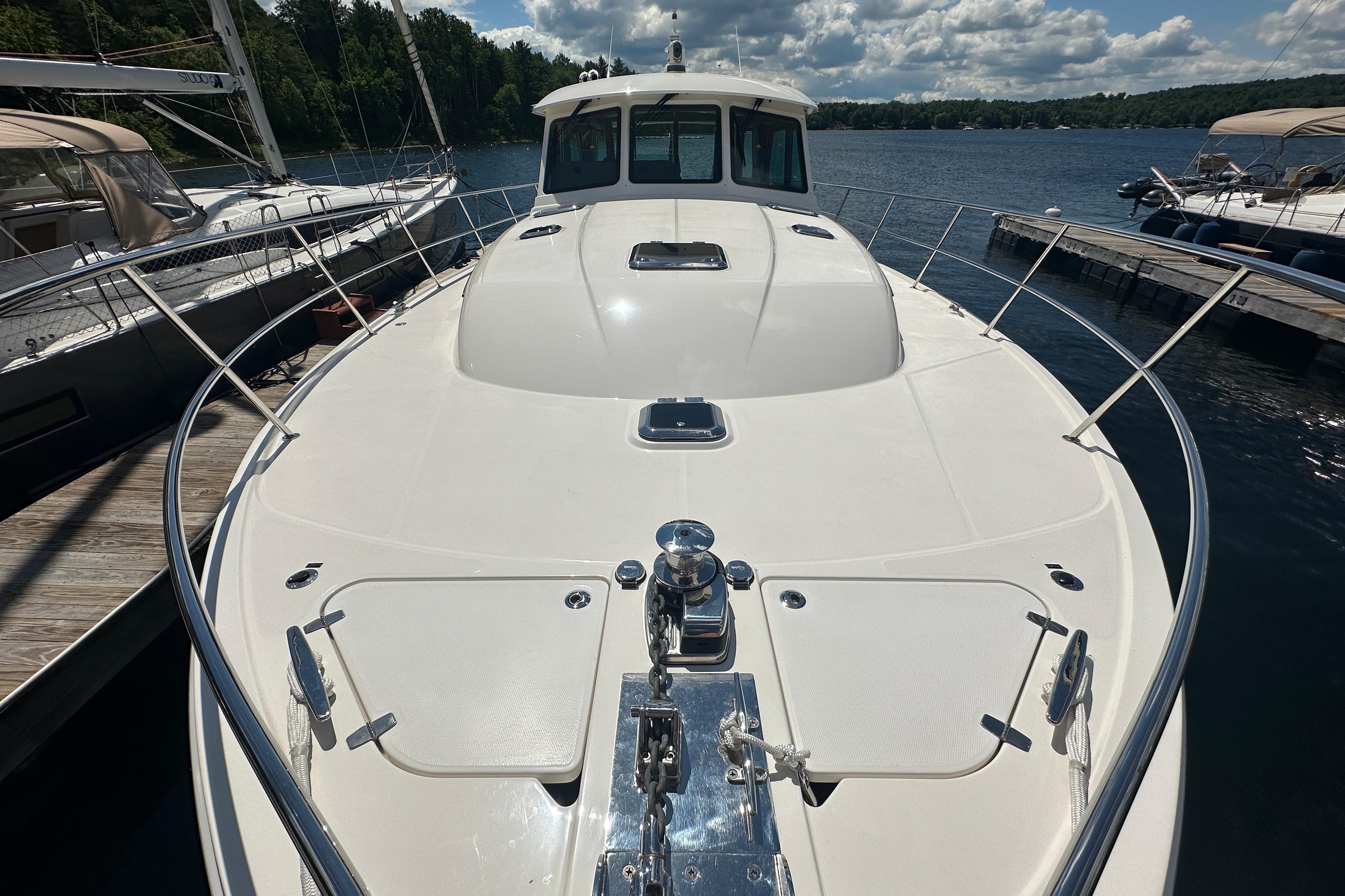 2025 Sabre 48 Salon Express yacht docked on a sunny day, showcasing sleek design.