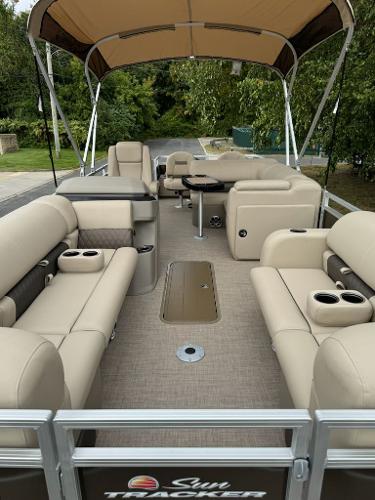 2025 Sun Tracker SportFish 22 XP3 pontoon boat with spacious seating and canopy.
