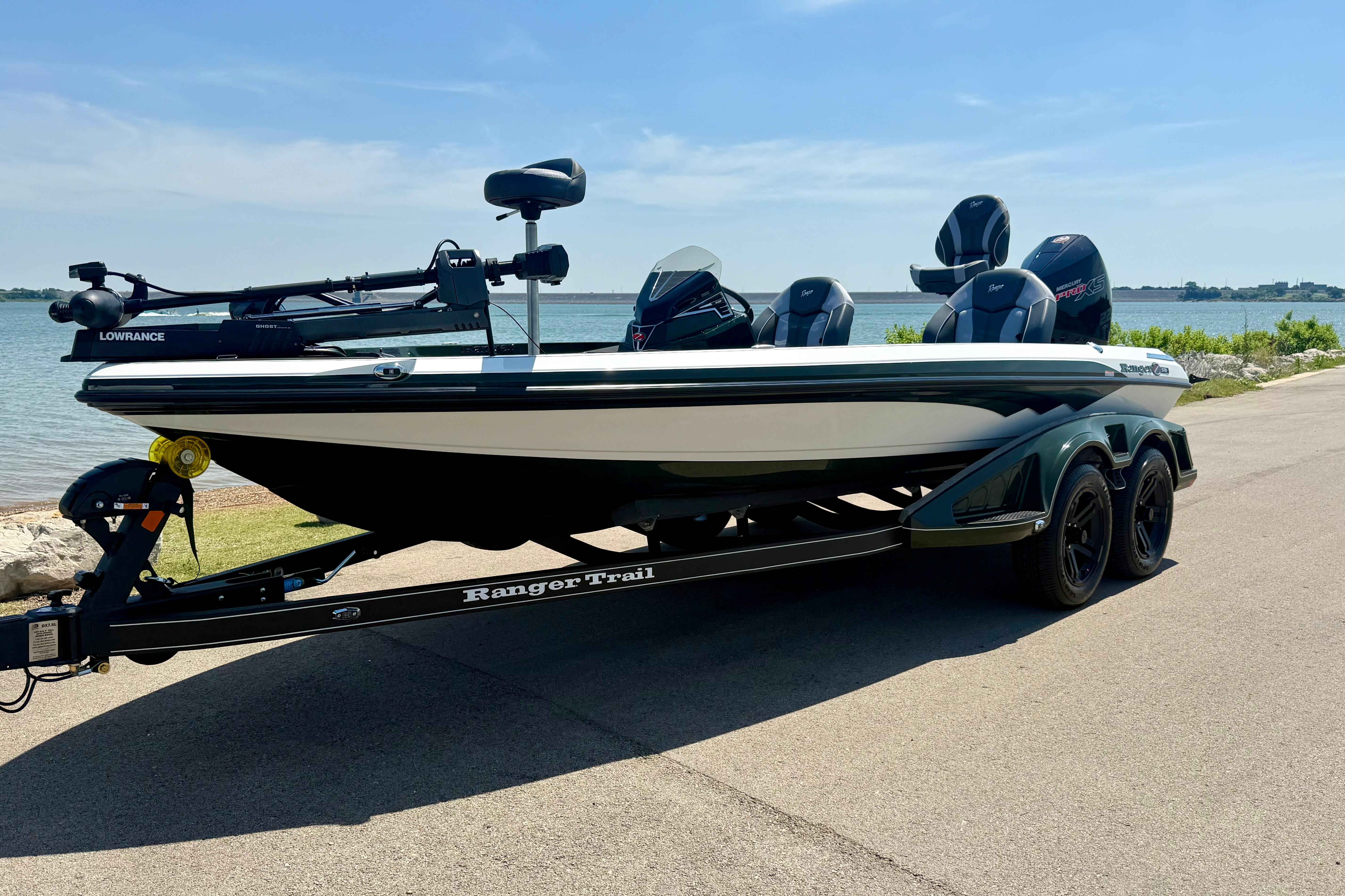 2026 Ranger Z519R boat on trailer by a lakeside road under clear sky.
