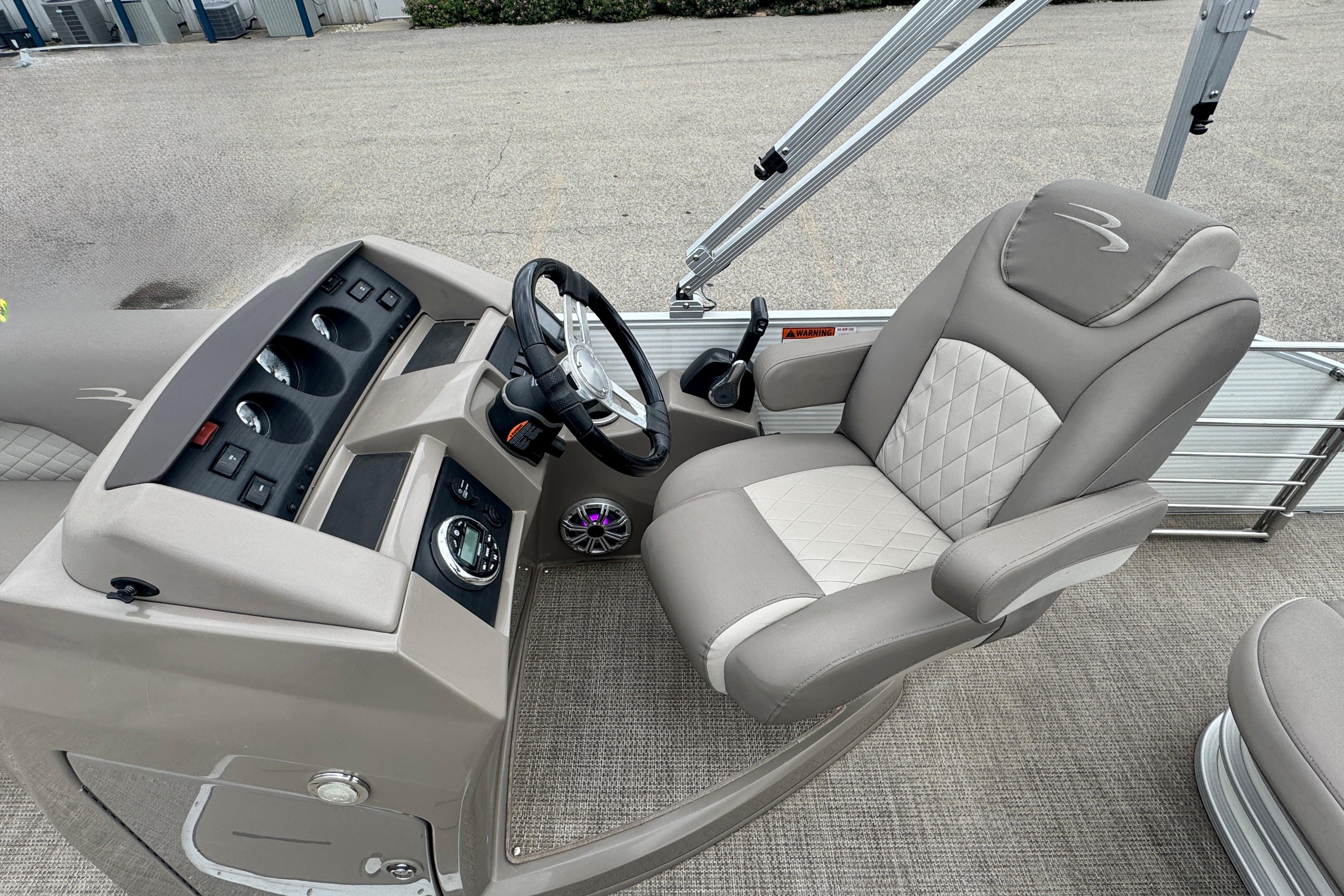 2019 Bennington SX 22 SSBXP boat helm with luxurious seating and modern controls.