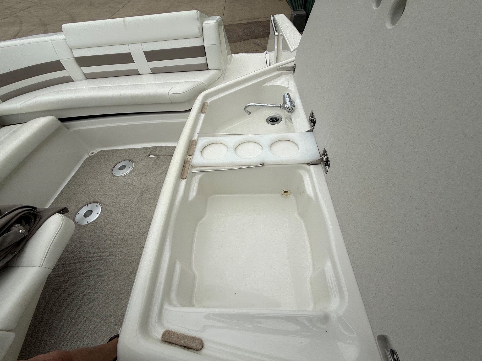 Interior of a 1998 Formula Thunderbird boat with seating area and sink.