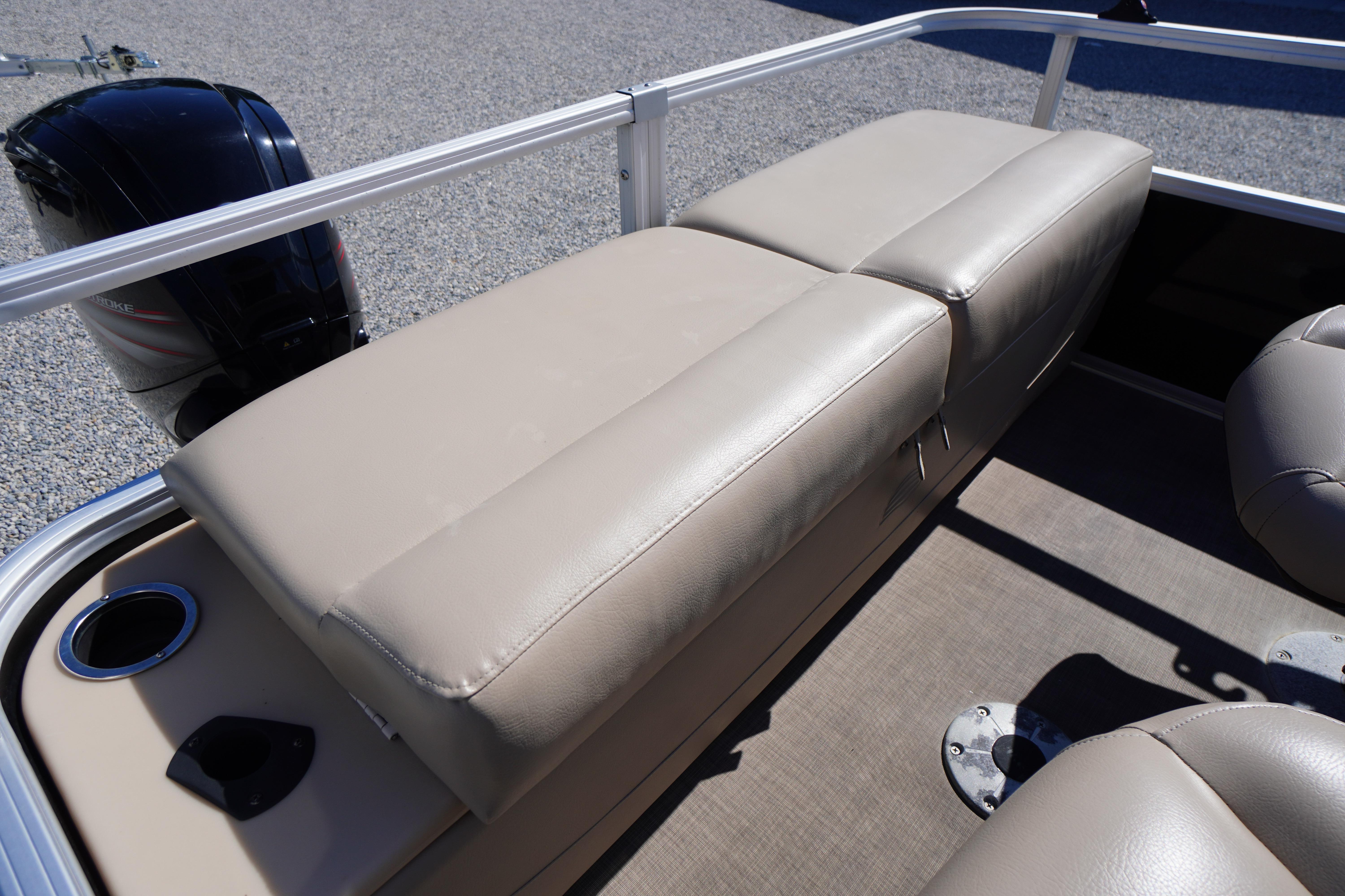 2019 SUNTRACKER Fishin' Barge 22 DLX boat interior with beige seating and cup holder.