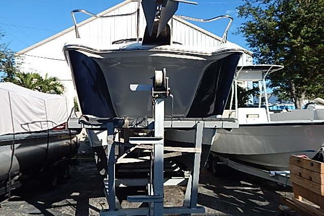2003 World Cat 270 EC boat on trailer, parked outdoors near other boats.