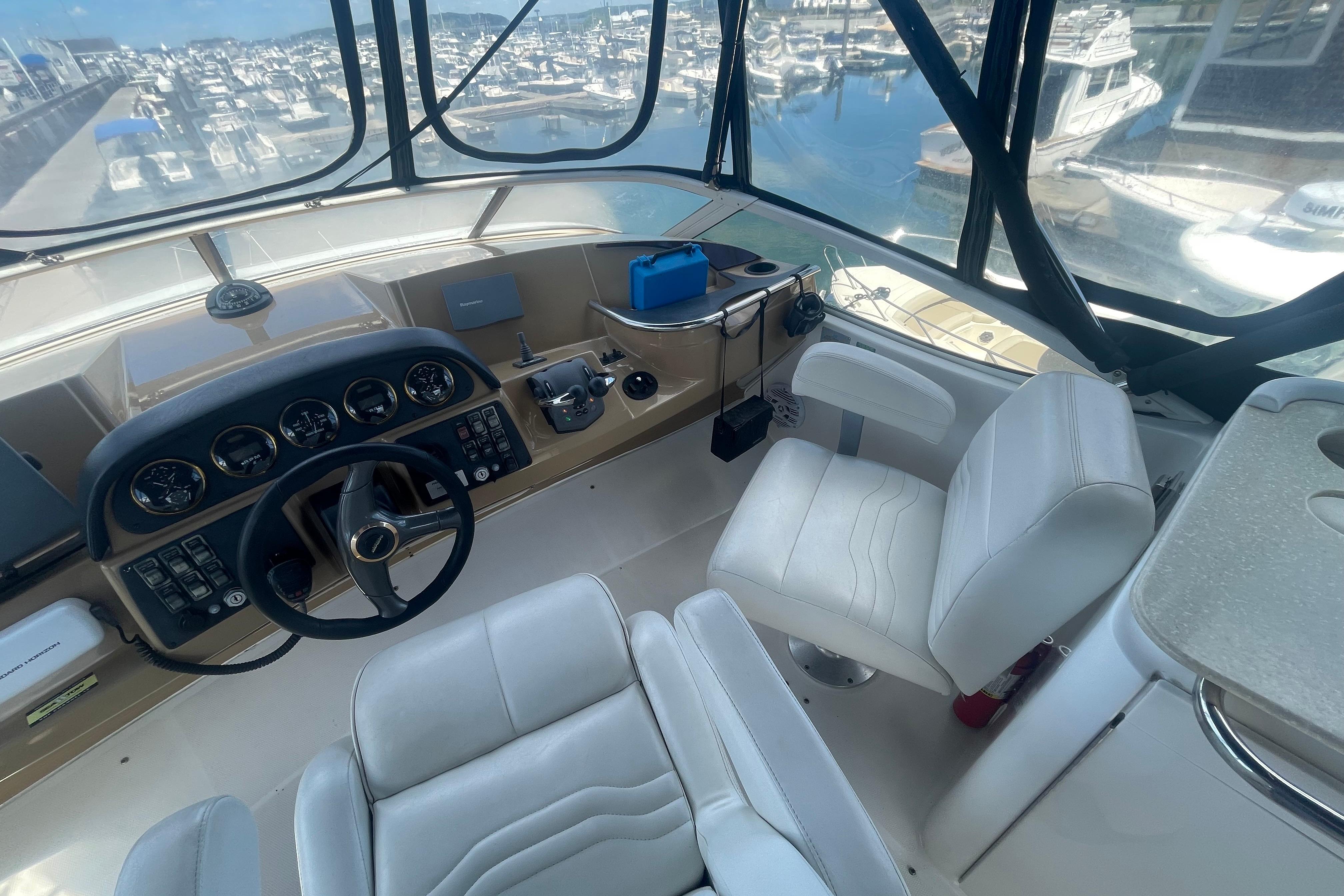 Interior view of 2002 Carver 410 Sport Sedan yacht cockpit with steering wheel and controls.