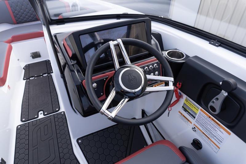 2026 Scarab 255 LX Wake boat dashboard with steering wheel and control panel.