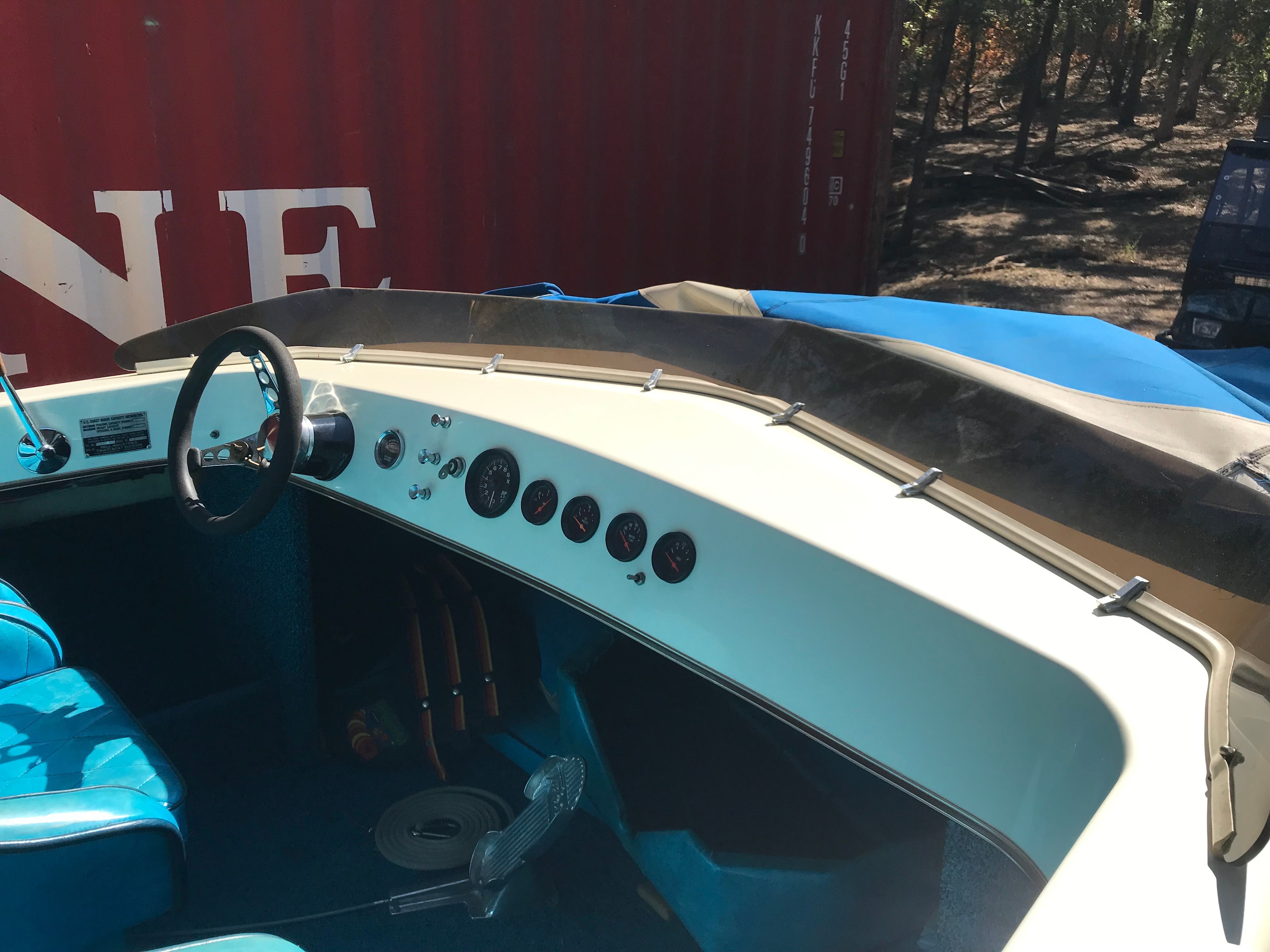 Interior of a 1976 Tahiti Day Cruiser boat with blue seats.