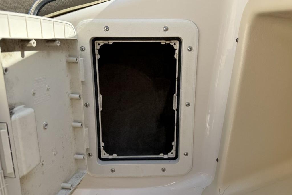 Open storage compartment on a 1999 Glastron GT 225 boat.