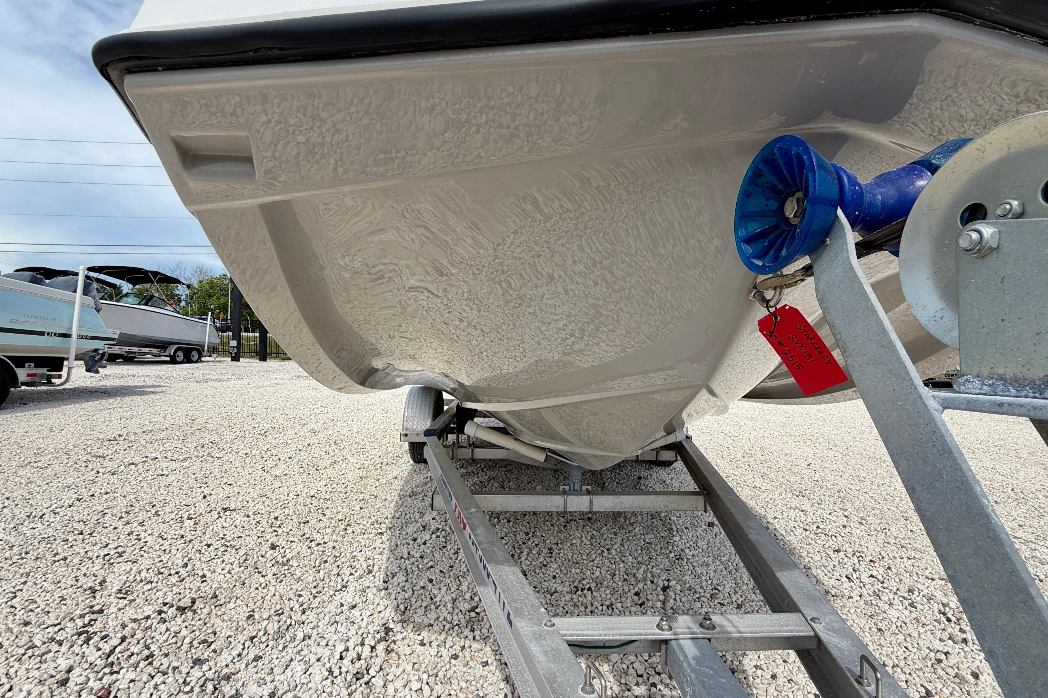 2021 Starcraft SVX 191 OB boat on trailer, showcasing hull design and trailer details.