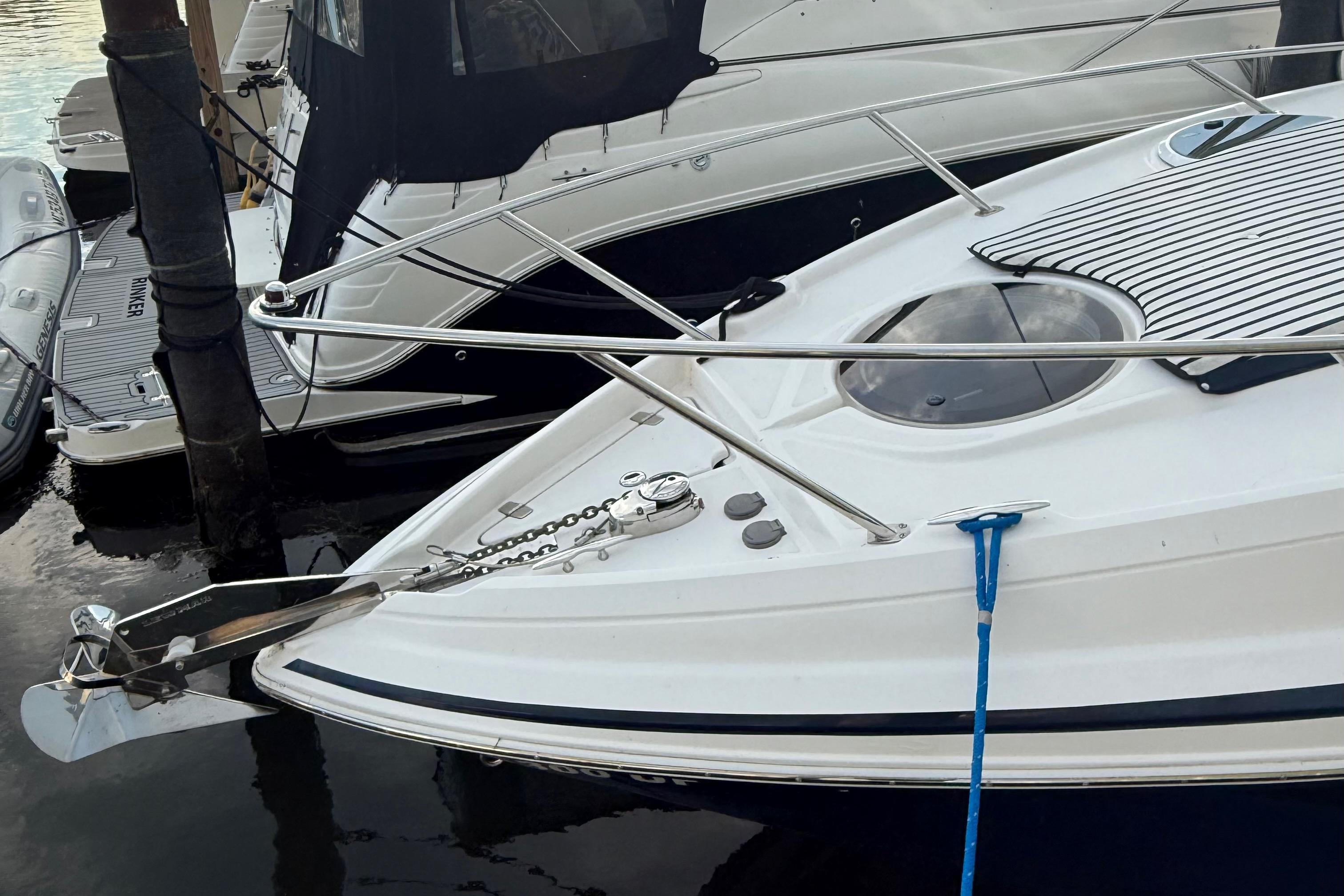 2018 Regal 28 Express boat docked, featuring sleek design and stainless steel railings.