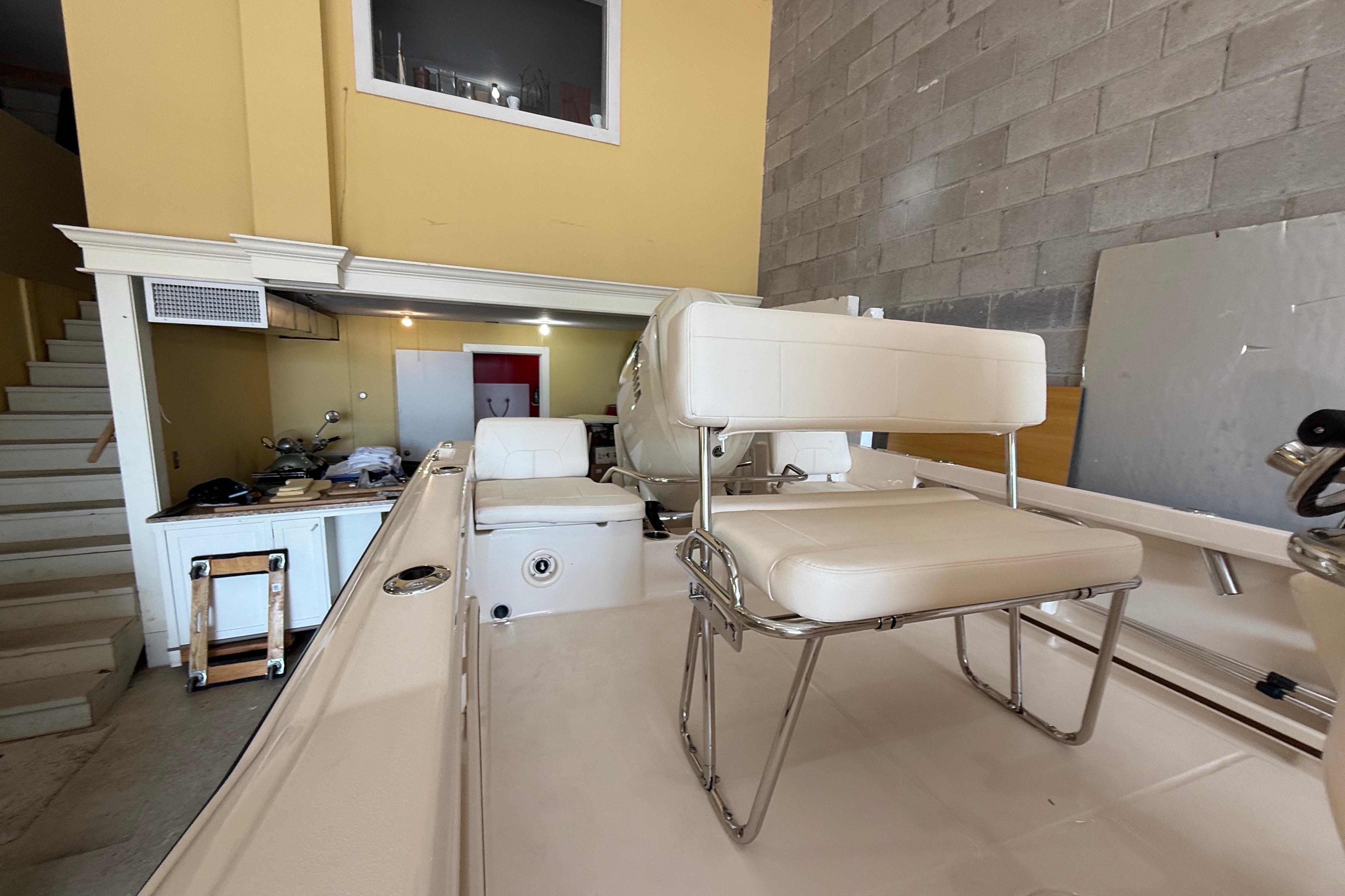 2025 Grady-White Fisherman 180 boat interior with seating, in a garage setting.
