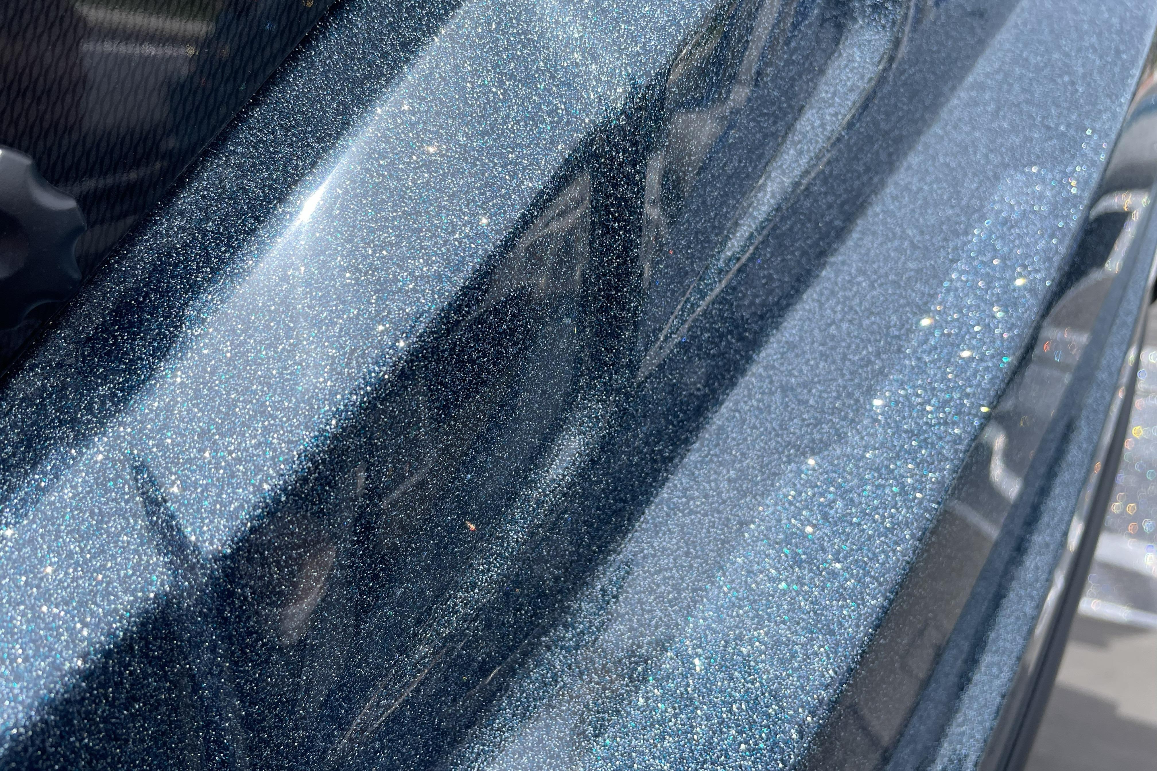 Metallic blue finish on 2026 Nitro Z21 XL boat, showcasing glittering paint detail.