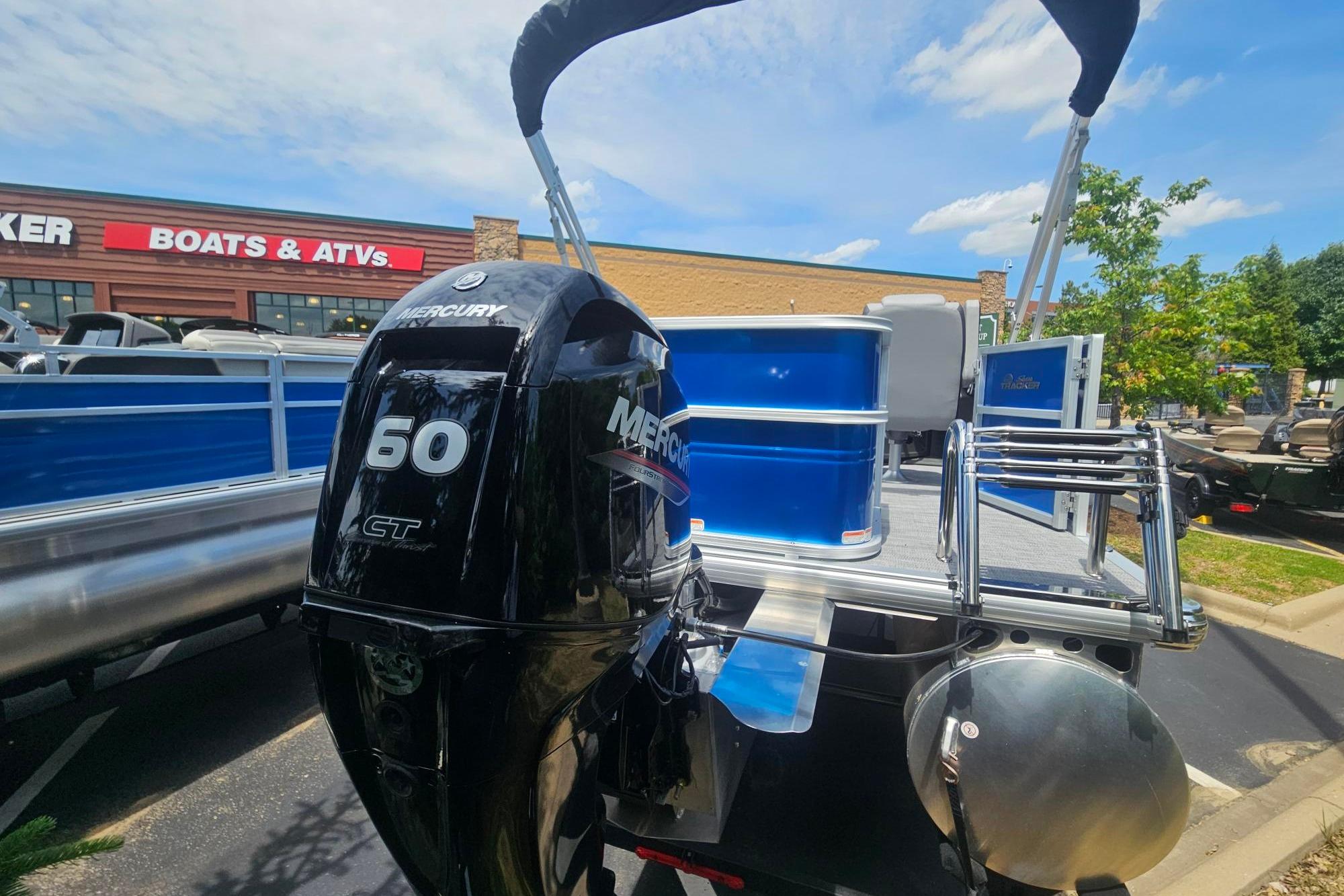 2026 Sun Tracker Party Barge 18 DLX with Mercury 50 CT engine at dealership.