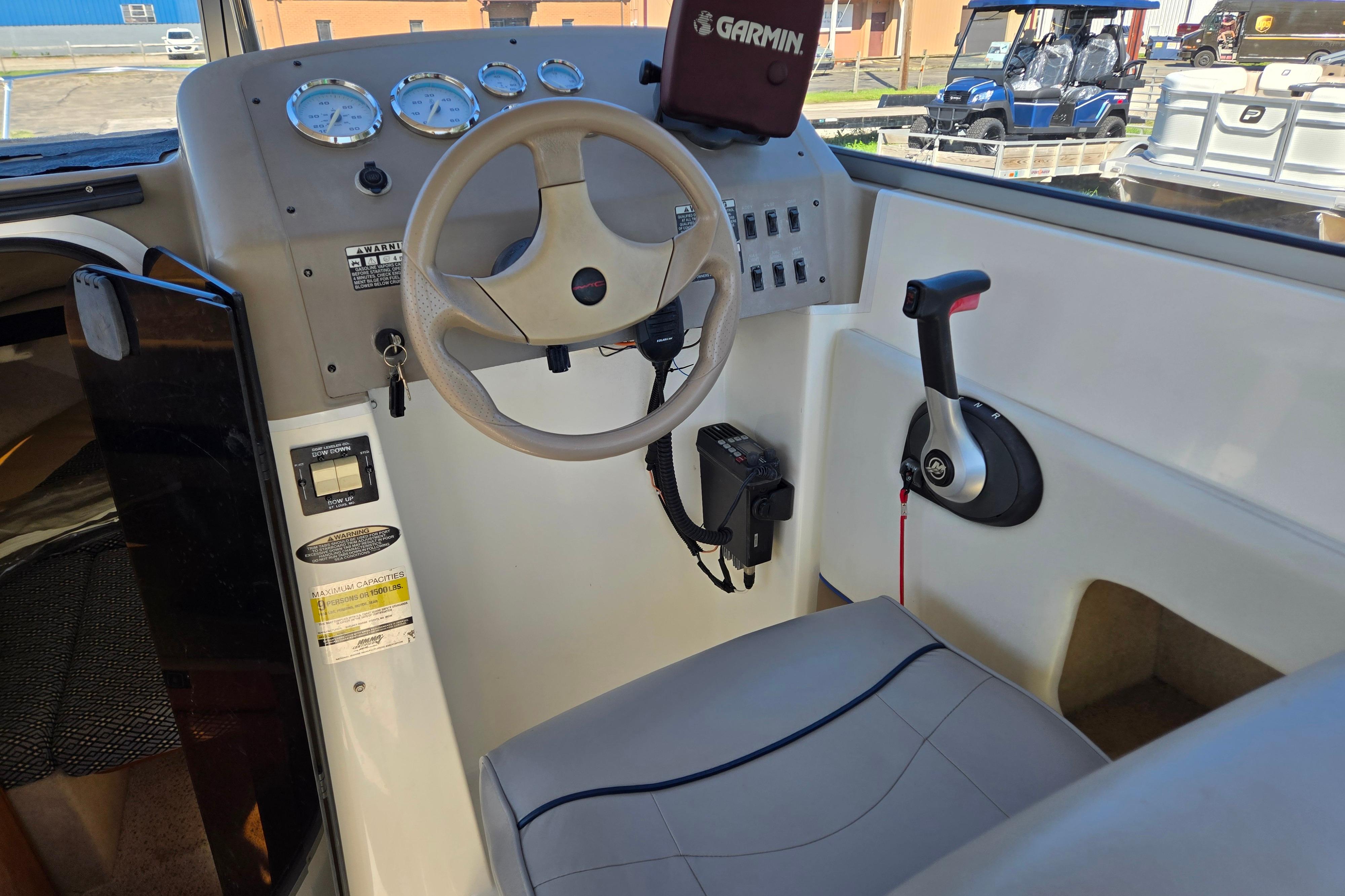 2006 Bayliner 222 Classic boat cockpit with steering wheel, gauges, and control panel.