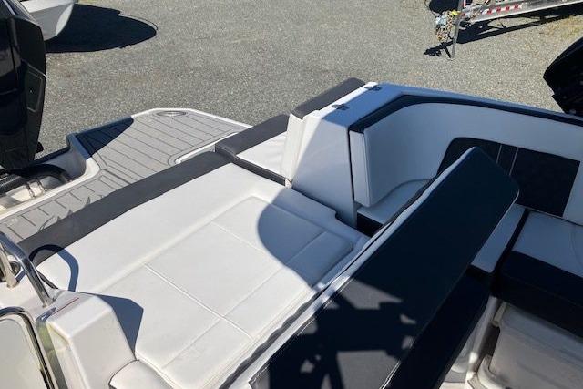 2024 Monterey M-65 boat interior with sleek white and black seating design.