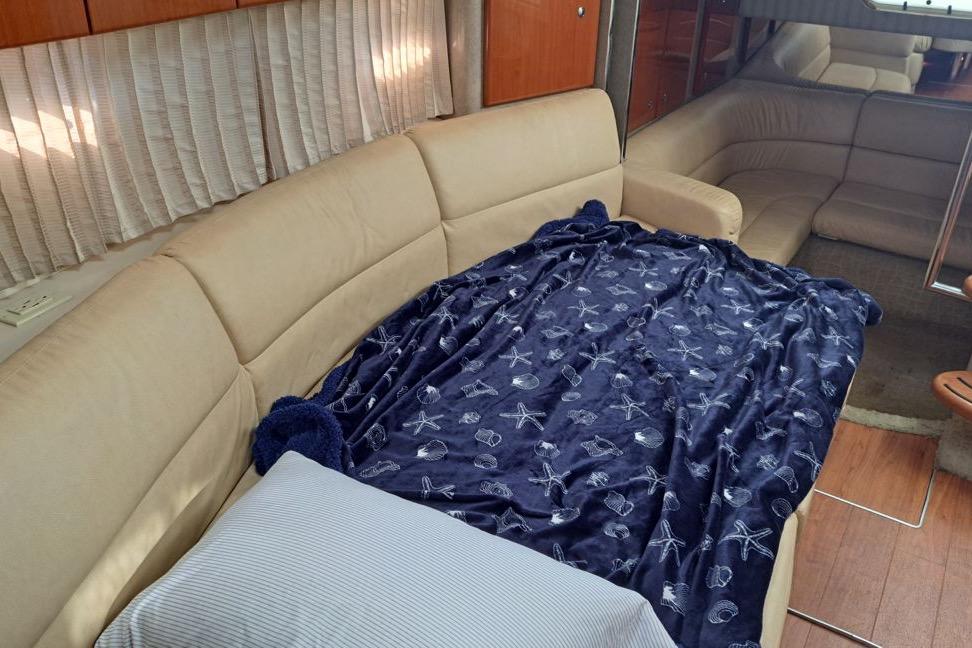 Interior of 2008 Formula 34 Performance Cruiser with beige seating and nautical-themed blanket.
