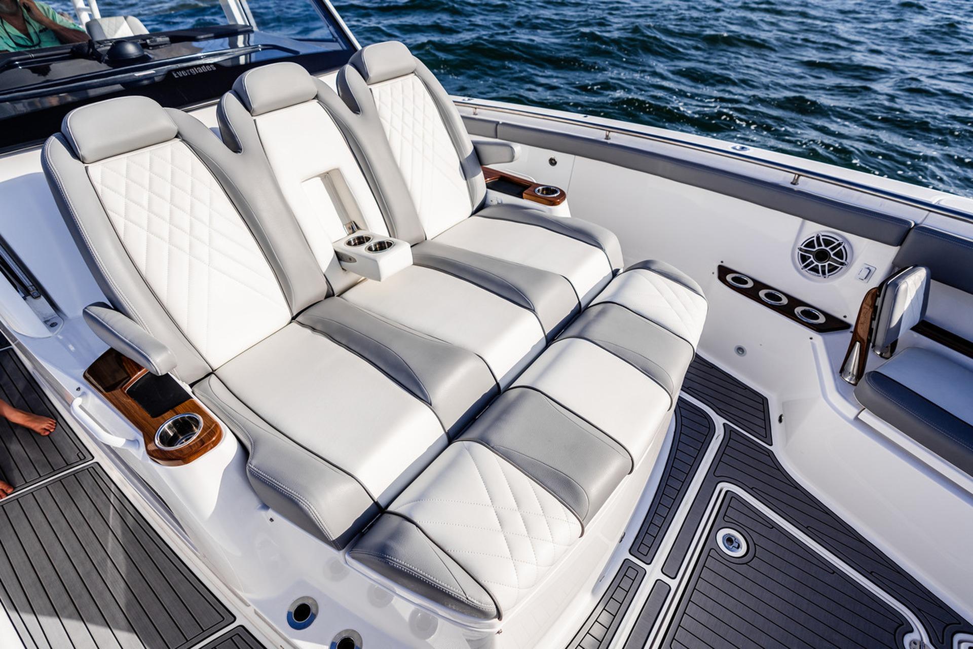 Luxurious seating on 2026 Everglades 455 Center Console boat, featuring elegant design and ocean backdrop.