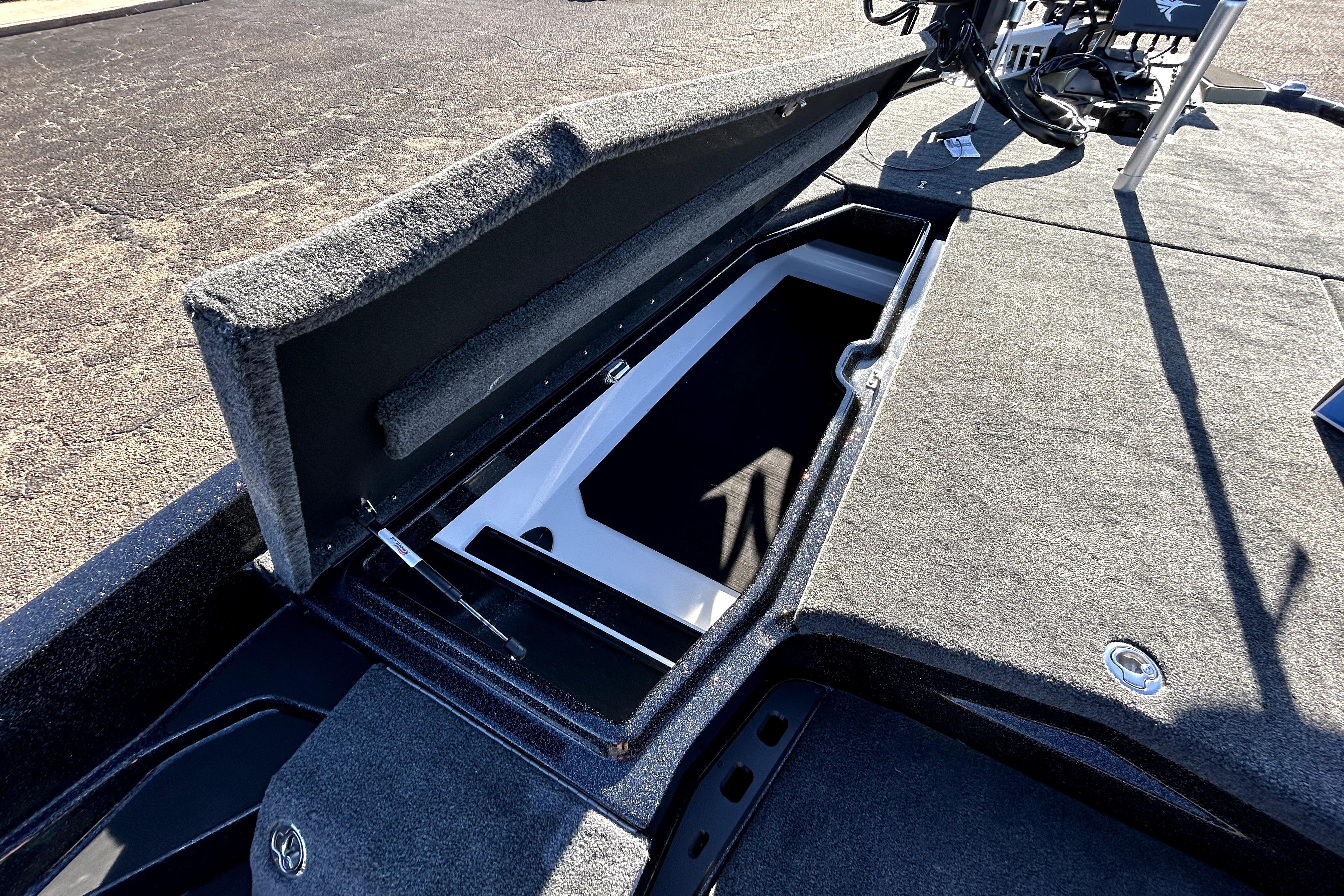 Open storage compartment on 2026 Skeeter ZXE21 boat, showcasing spacious interior design.