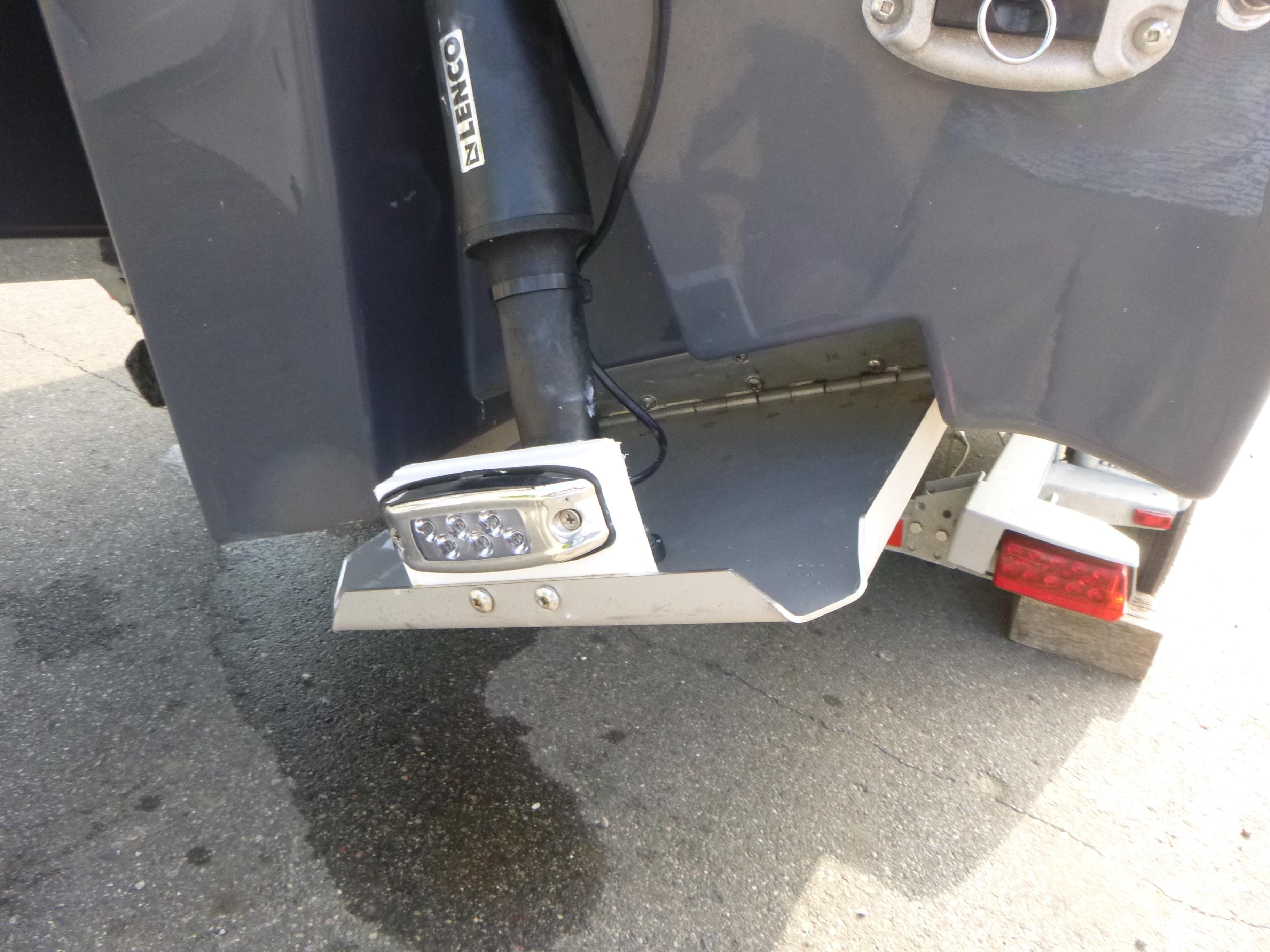 Rear view of Solara S-250 CW boat with Lenco trim tab and LED light.