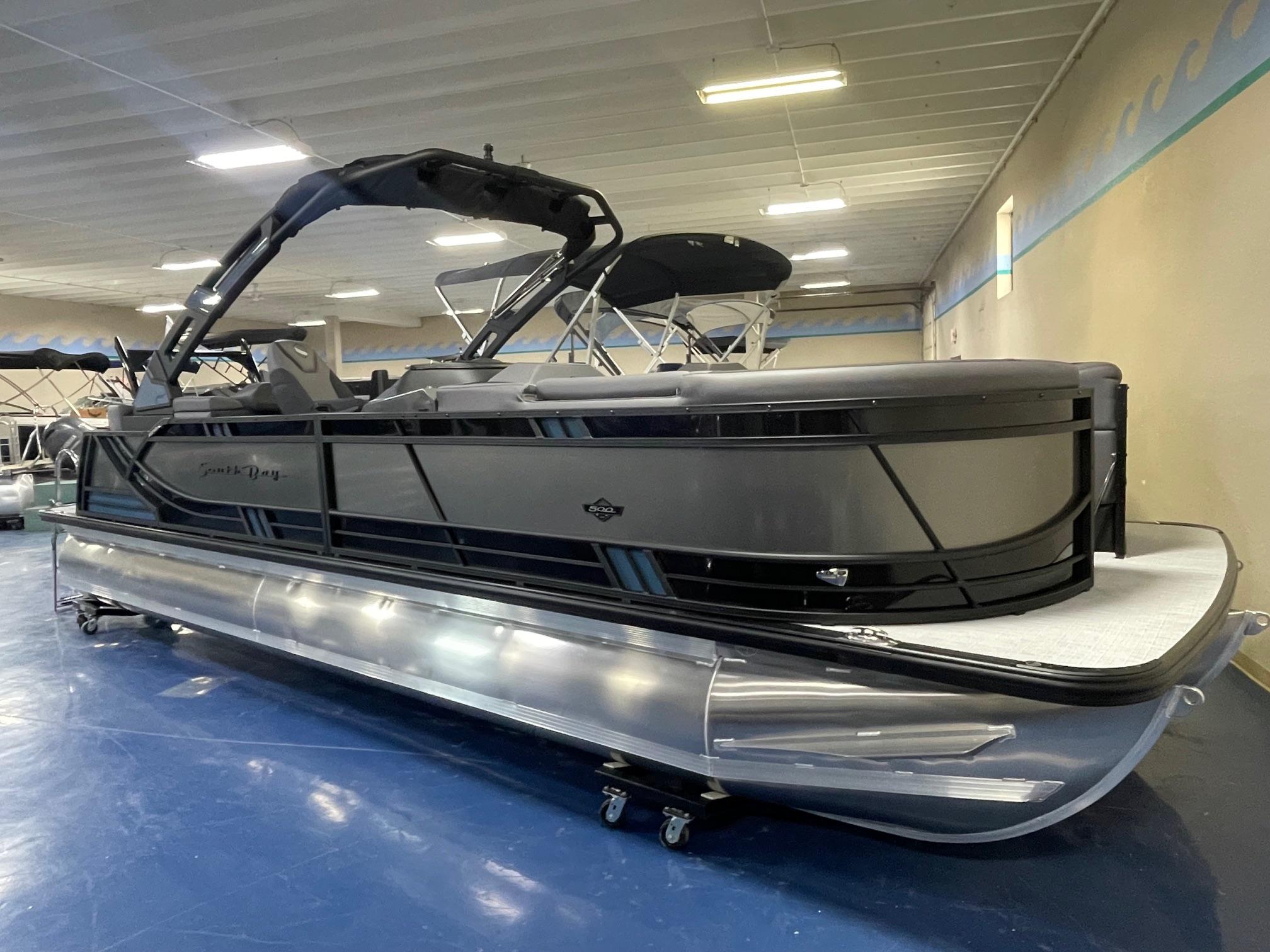 2026 South Bay 525 RS 3.0 Arch pontoon boat in showroom, sleek design, black finish.