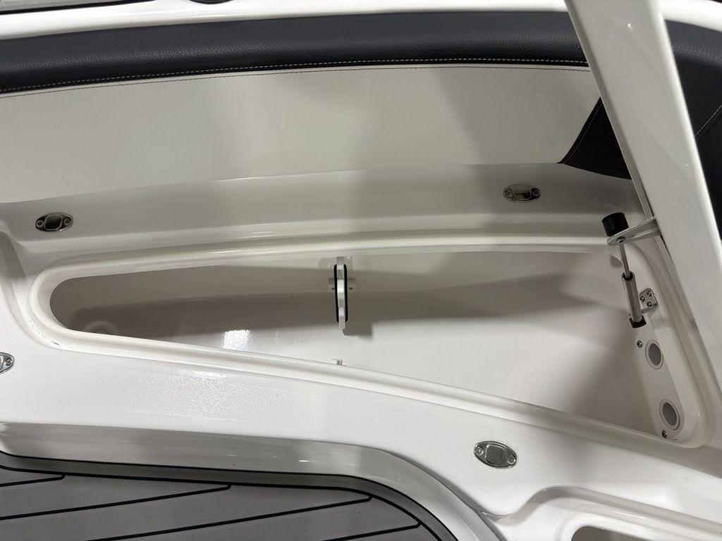 Open storage compartment on 2026 Tidewater 2700 CB boat, featuring sleek white interior design.