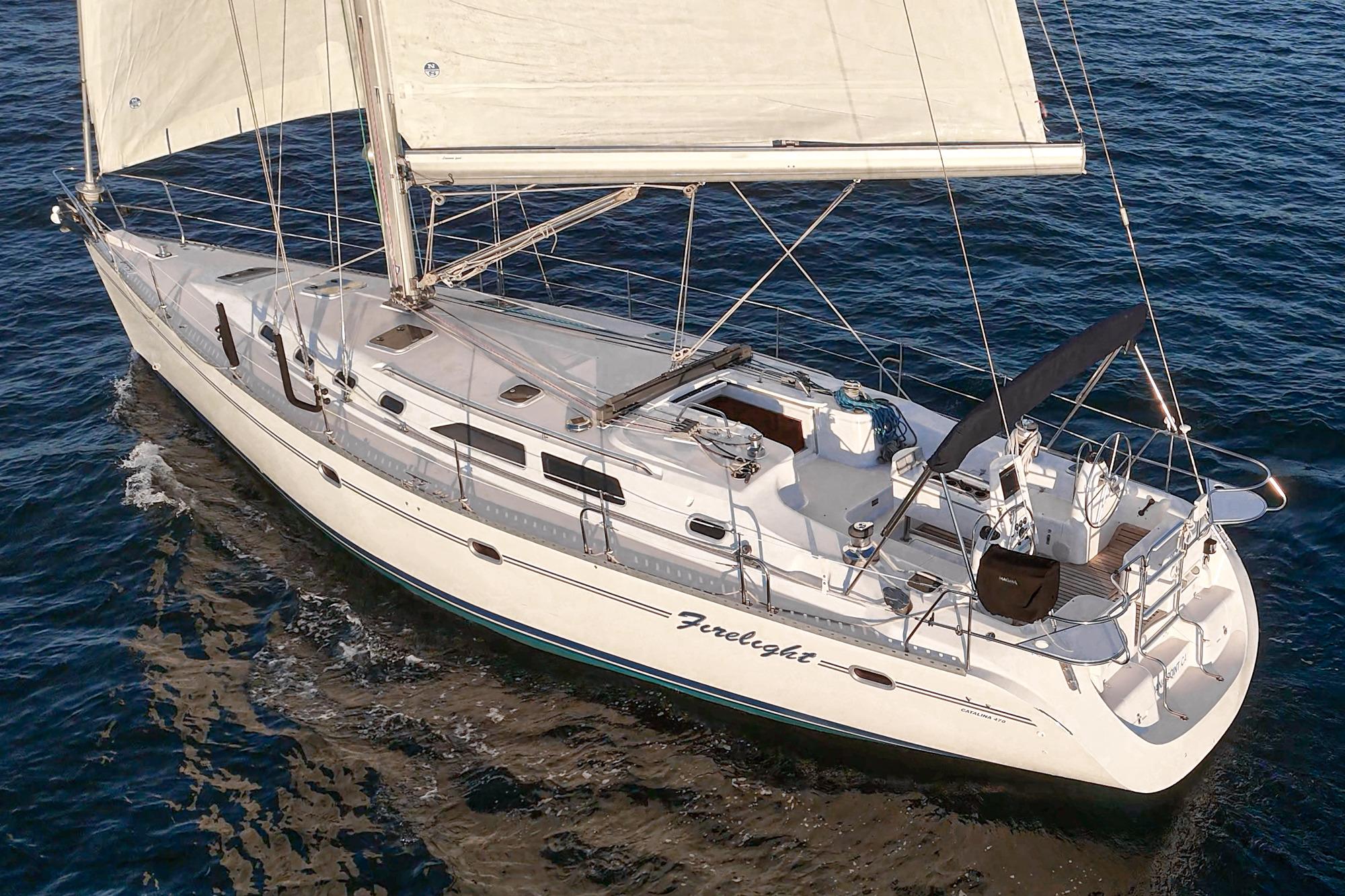 Sailing yacht Catalina 470, 1999 model, cruising on open water.