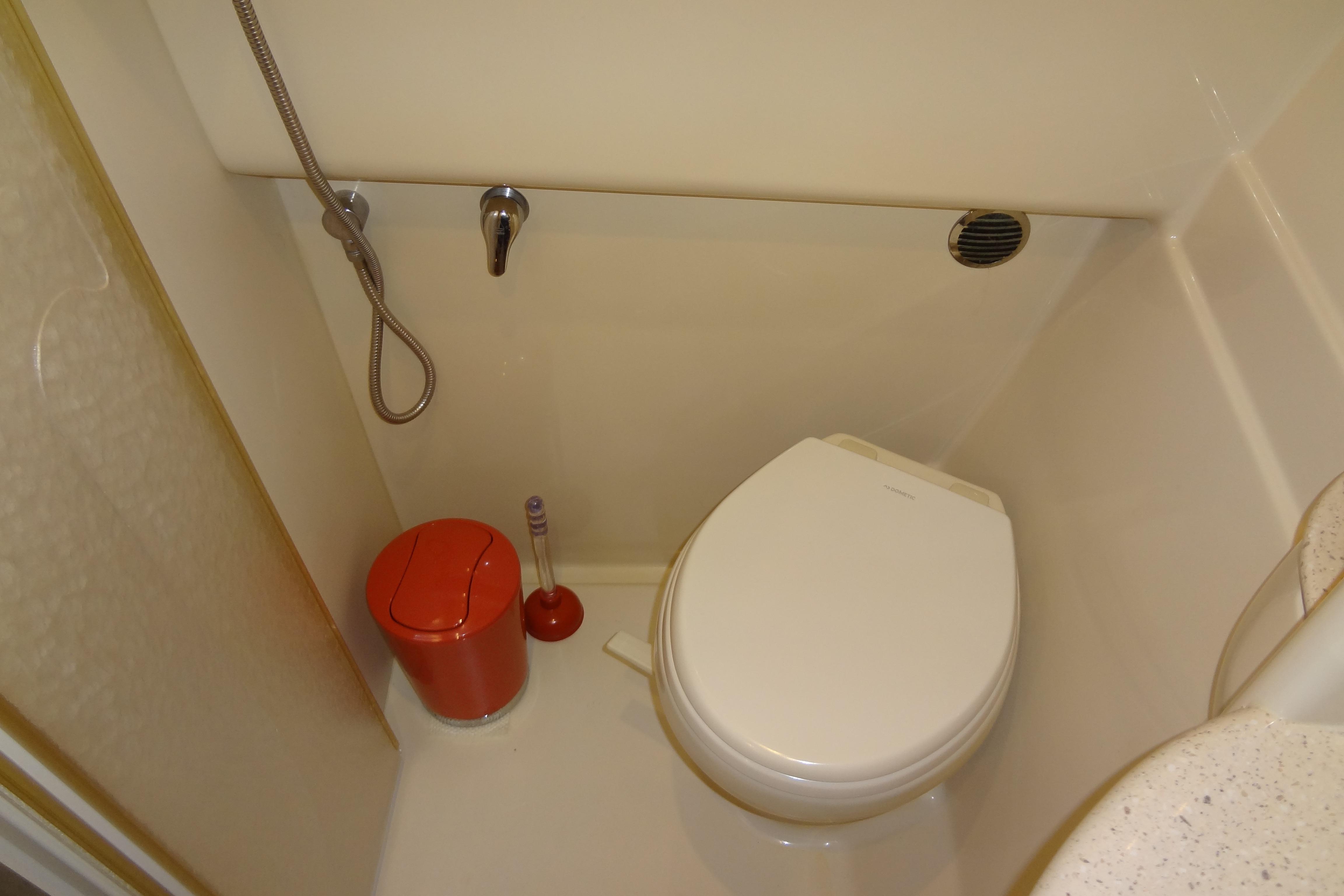 2007 Formula 34 Performance Cruiser bathroom with toilet, shower, and red waste bin.