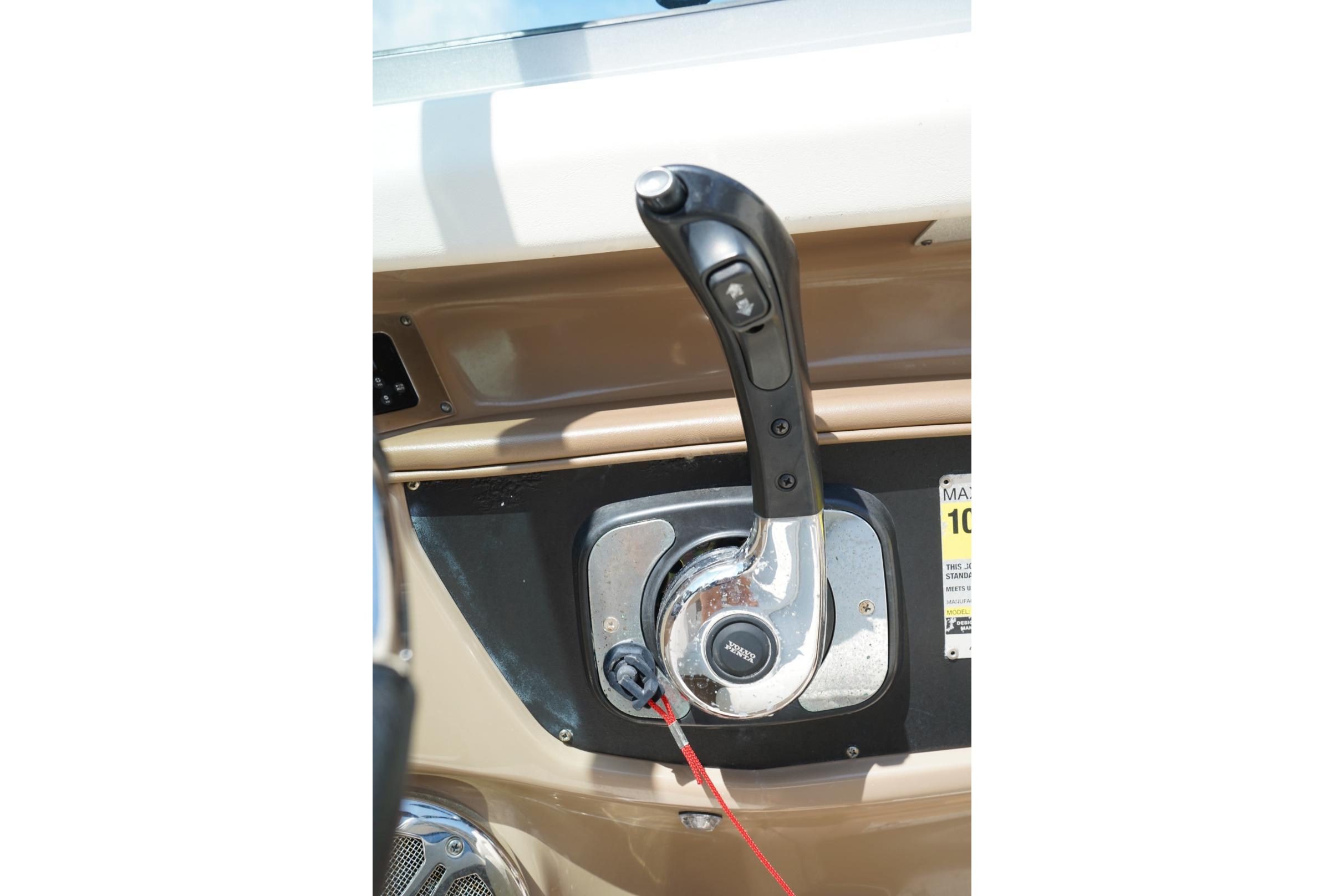 Throttle control of a 2013 Chaparral 206 SSi boat, featuring a sleek design.