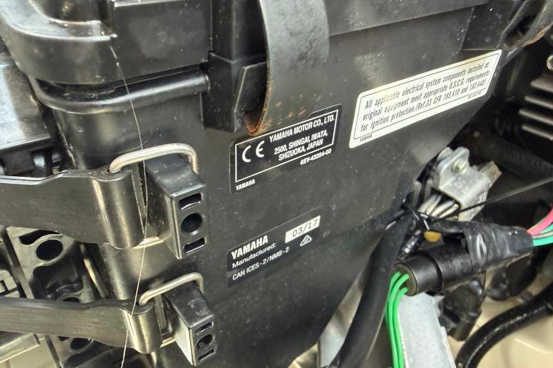 Close-up of a 2017 Yamaha SX210 engine component with manufacturer labels and wiring.
