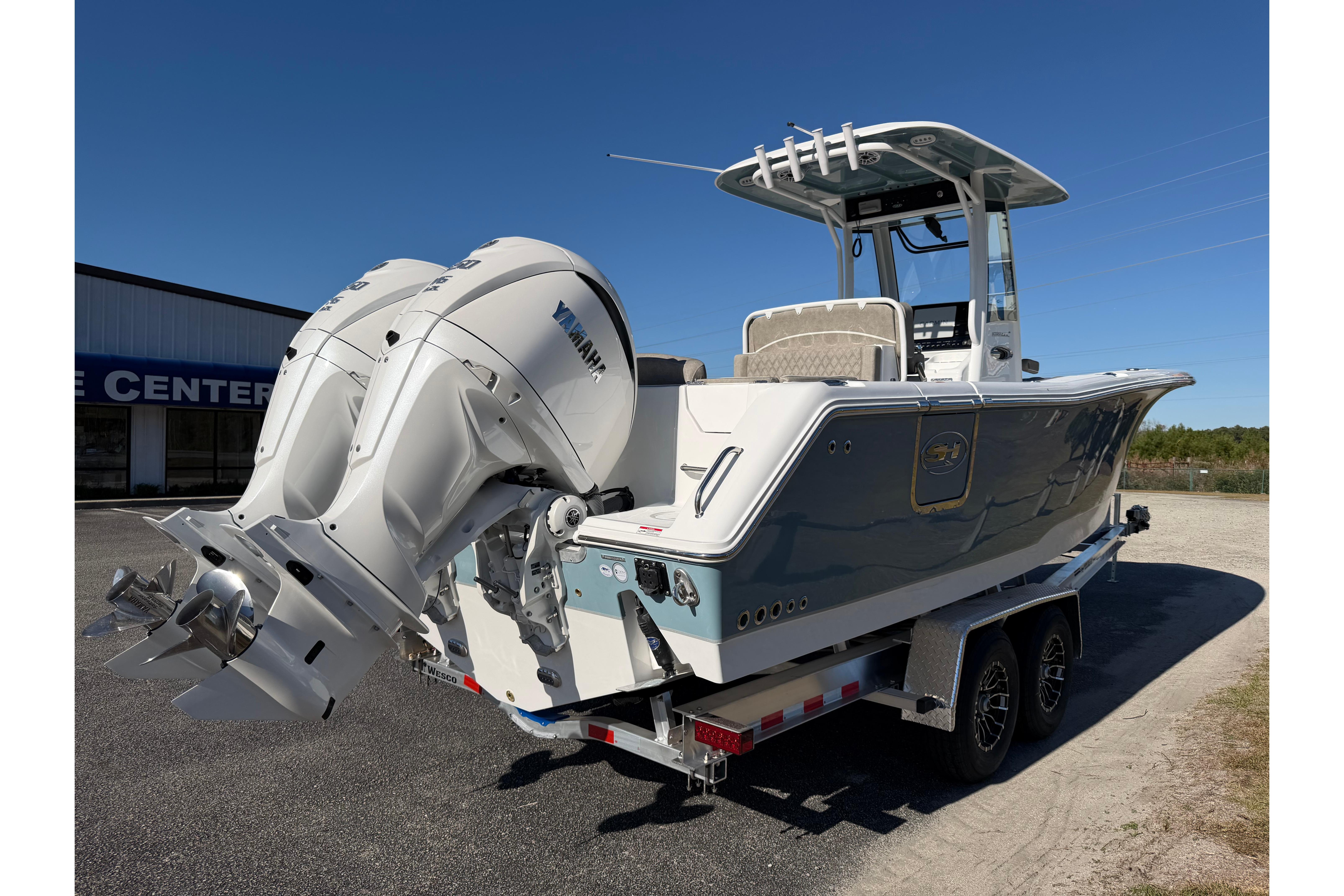2026 Sea Hunt Ultra 275 Coffin Box boat with dual Yamaha engines on a trailer.