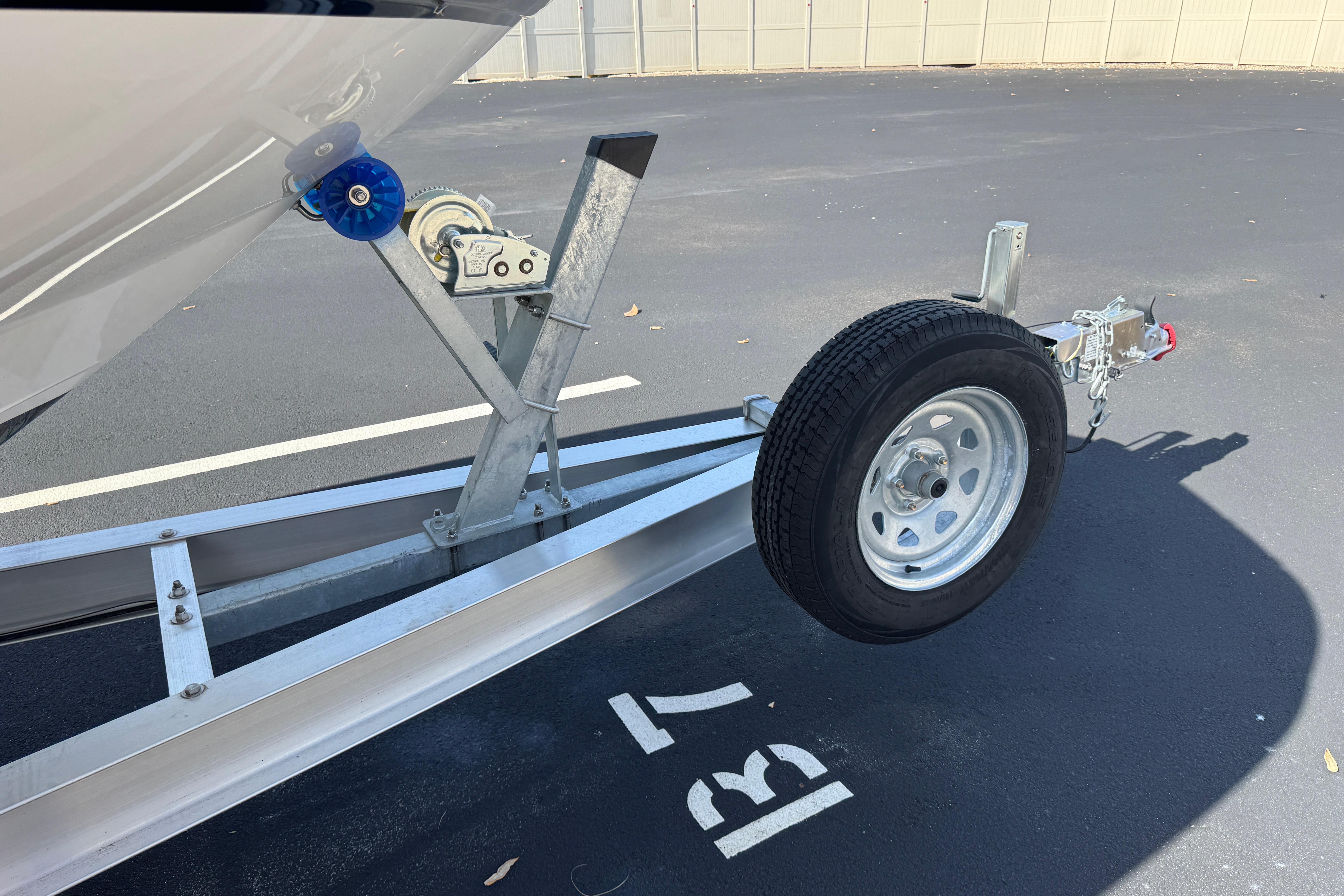 Trailer for 2018 Hurricane SunDeck 2400 OB boat in parking space B7.