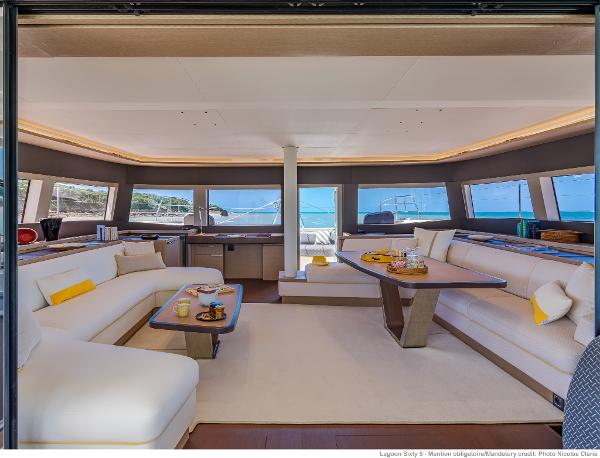 Luxurious interior of 2025 Lagoon SIXTY 5 yacht with elegant seating and ocean view.