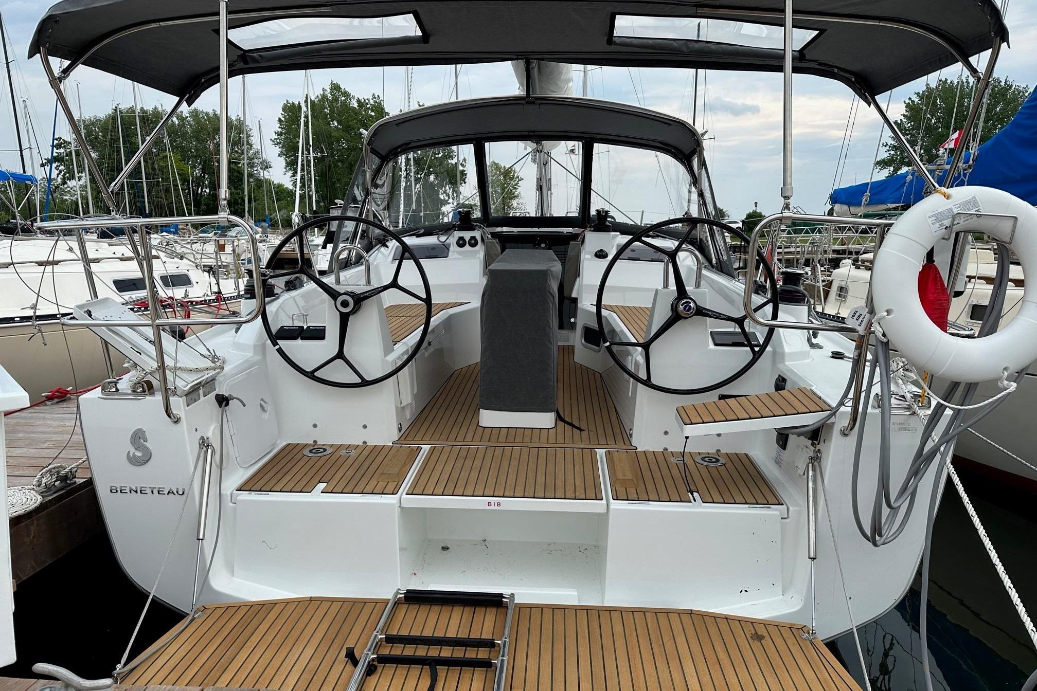 2023 Beneteau Oceanis 34.1 sailboat cockpit with dual steering wheels and teak decking.