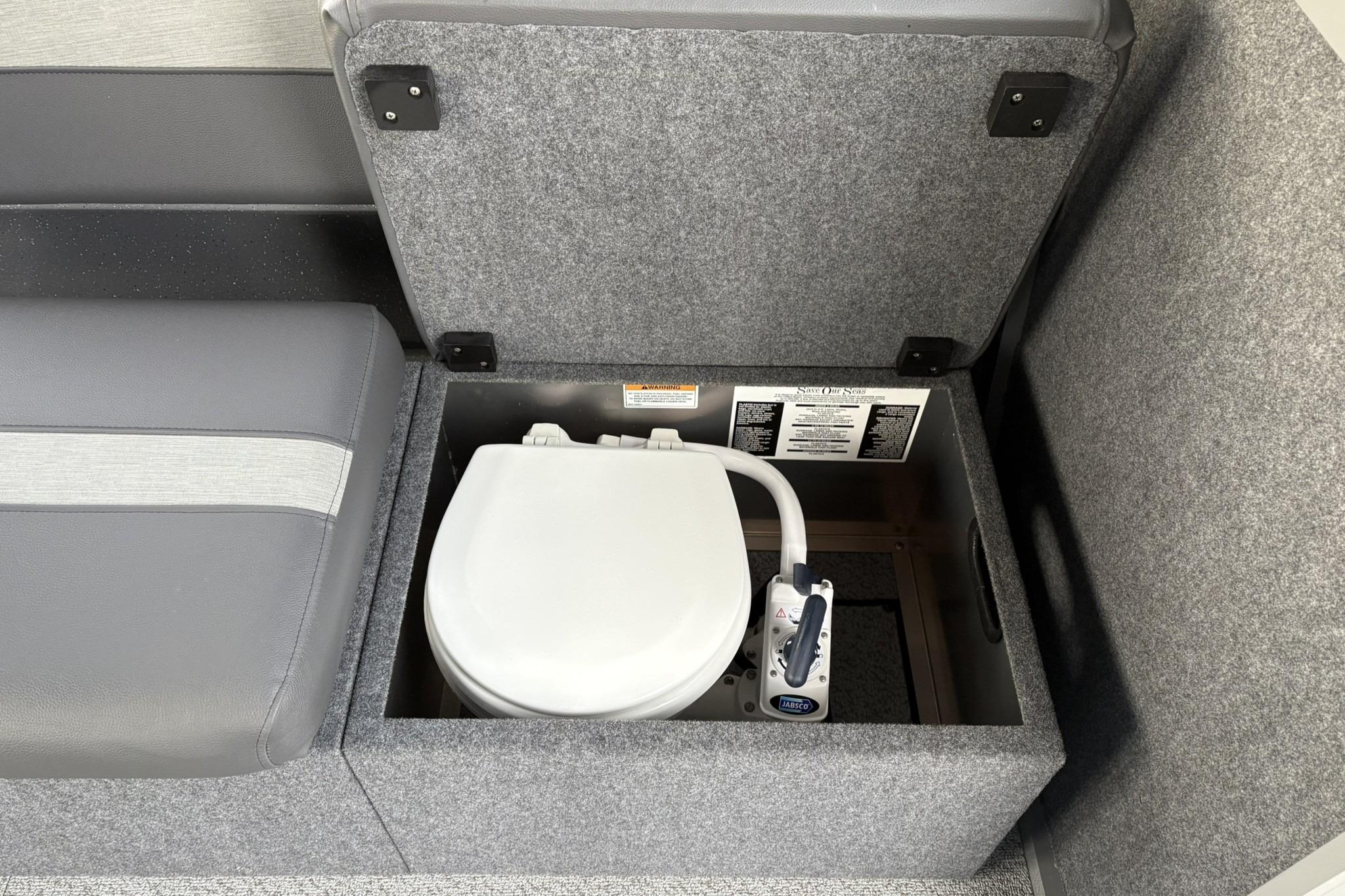 2024 Spartan 26 Maximus Pro XL interior with hidden toilet compartment.