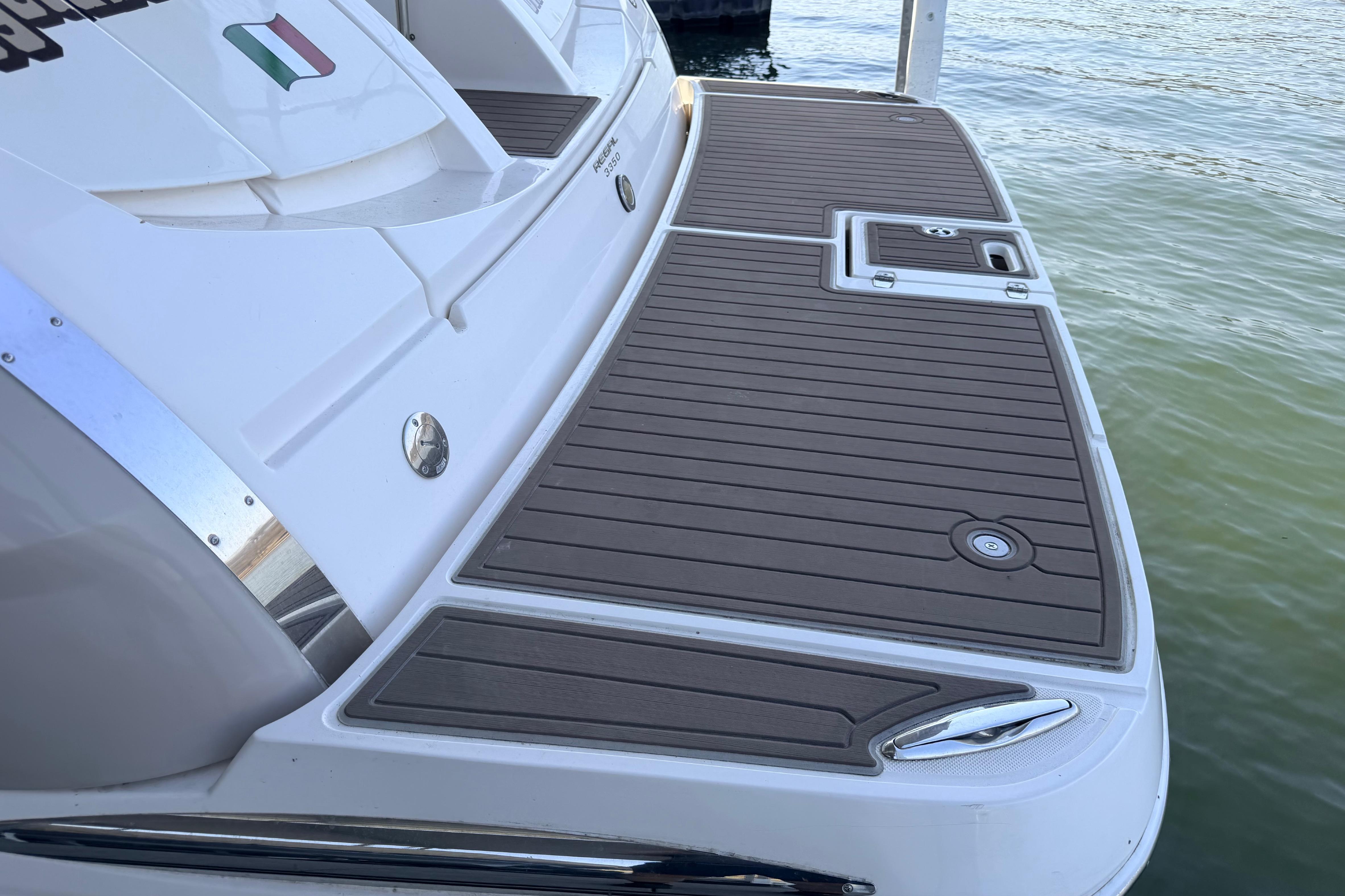 2005 Regal 3350 Sport Cruiser swim platform with teak decking by the water.