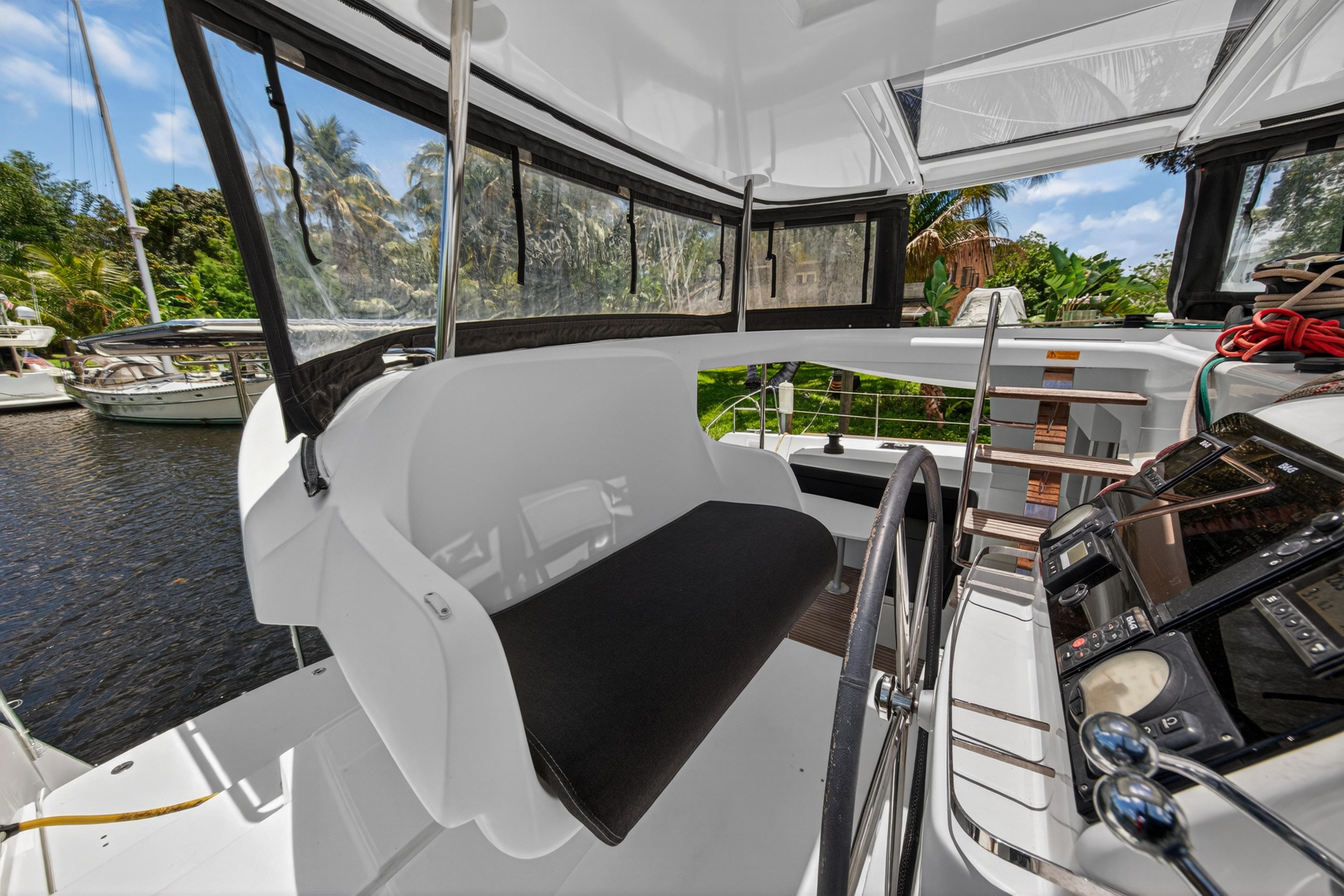 Cockpit of 2019 Lagoon 450 S catamaran with steering wheel and navigation instruments.