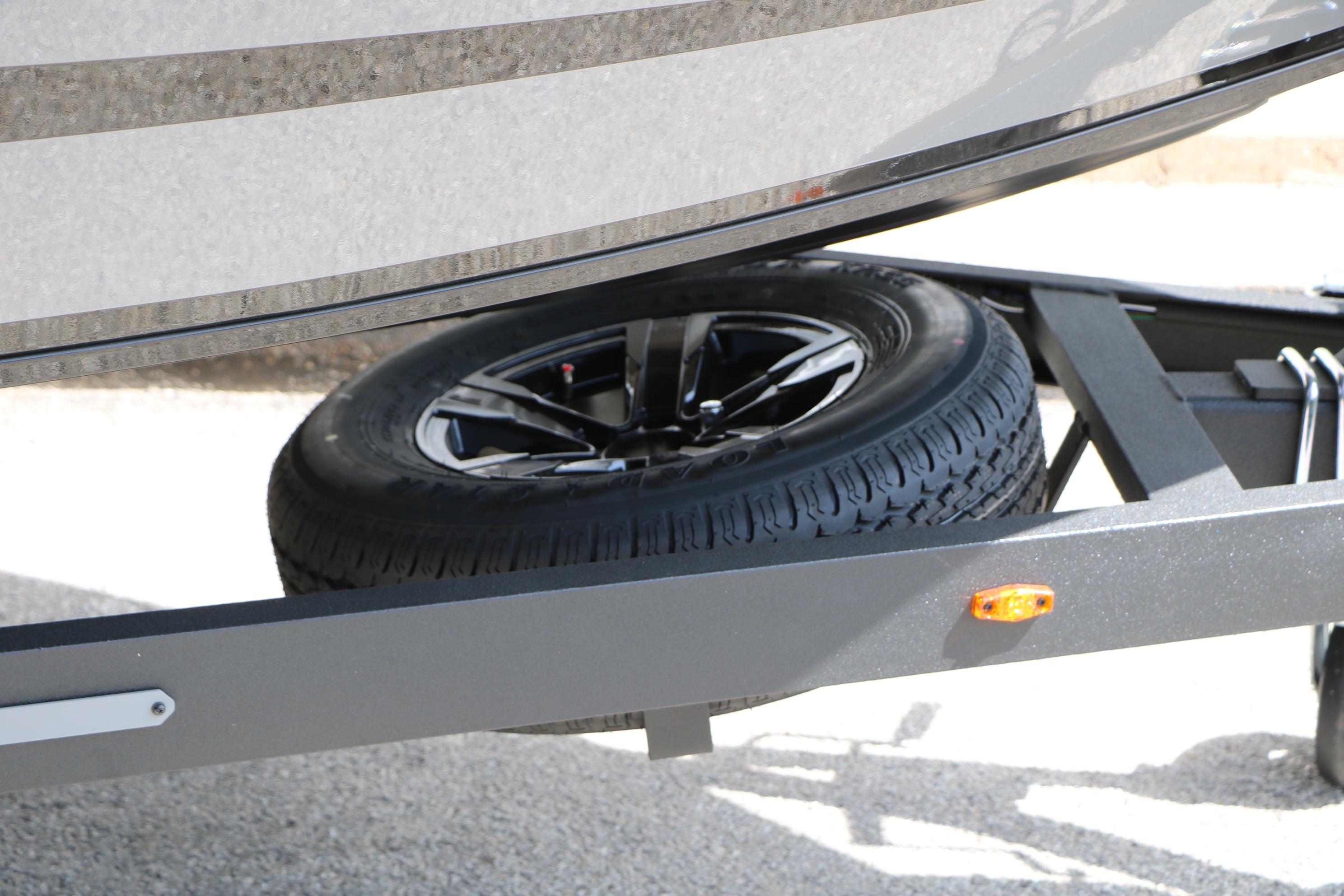 2026 Vexus AVX1980 trailer with spare tire and sleek black wheel design.