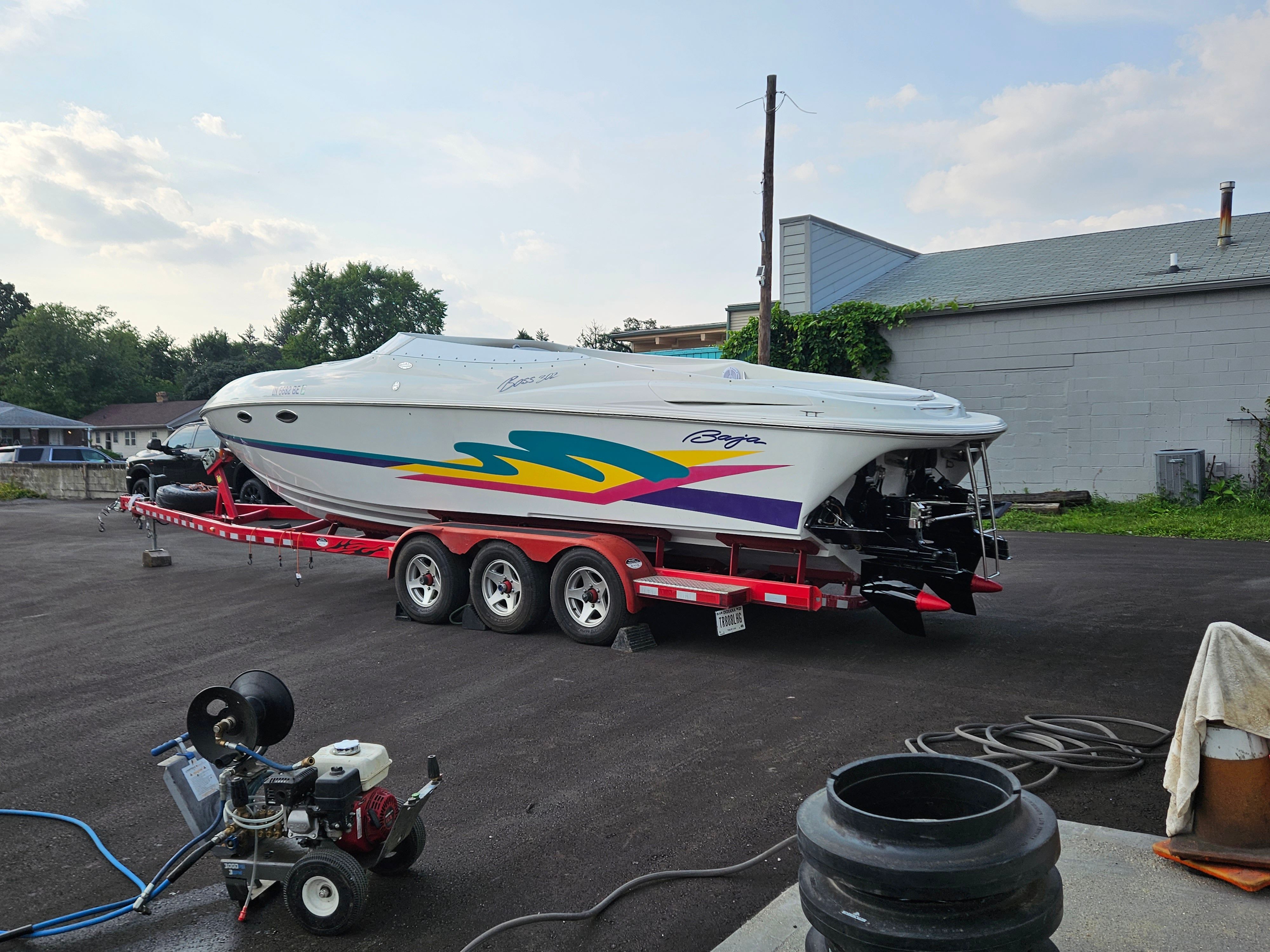 A 1996 Baja 302 Boss on a trailer, featuring colorful graphics and twin engines.