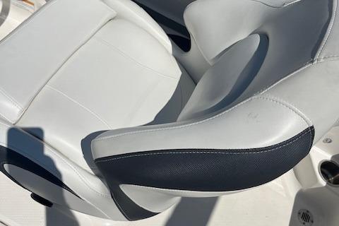 2015 Chaparral 21 H2O Sport boat seat with white and black upholstery.