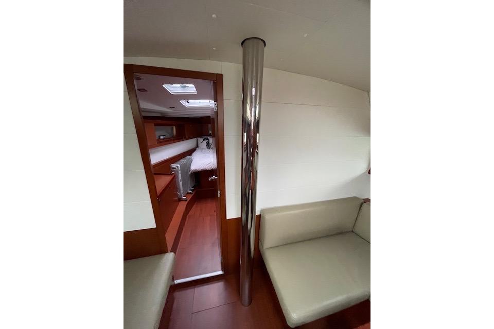 Interior of 2018 Beneteau Oceanis 45 yacht, featuring cozy seating and a cabin view.