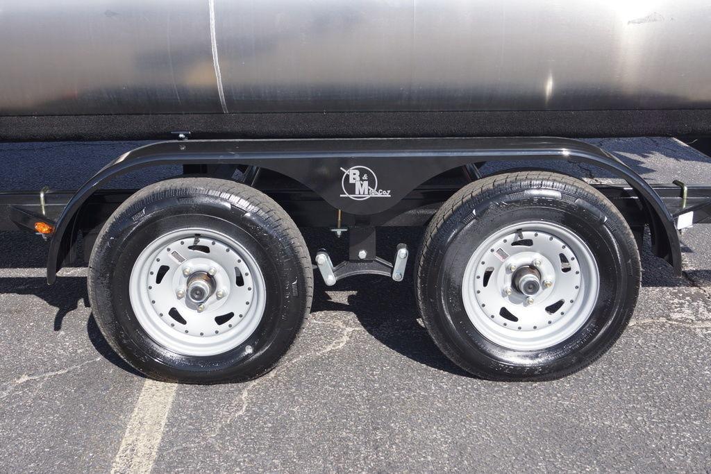 Trailer wheels of 2026 Avalon GS Quad Lounge - 18' on asphalt surface.