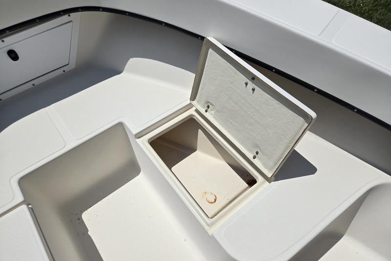 Open storage compartment on a 2000 May-Craft 2000CC boat deck.