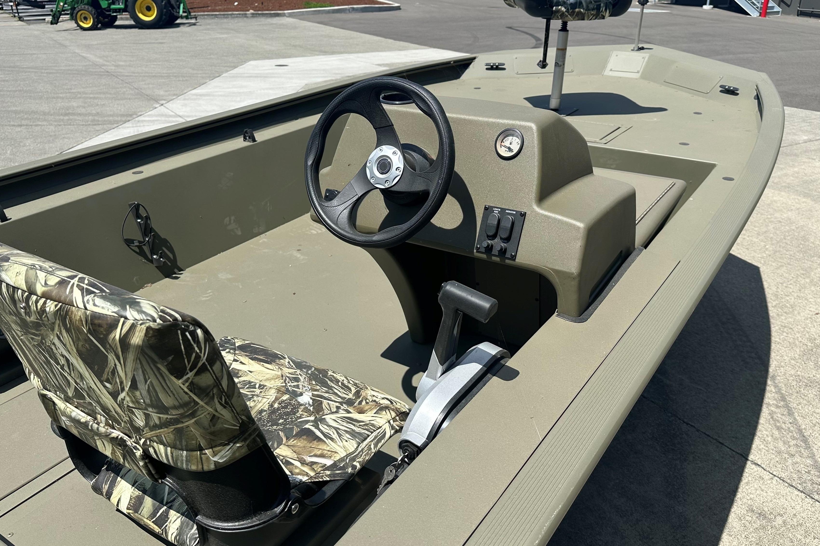 2026 Tracker Grizzly 1754 SC boat interior with camo seat and steering console.