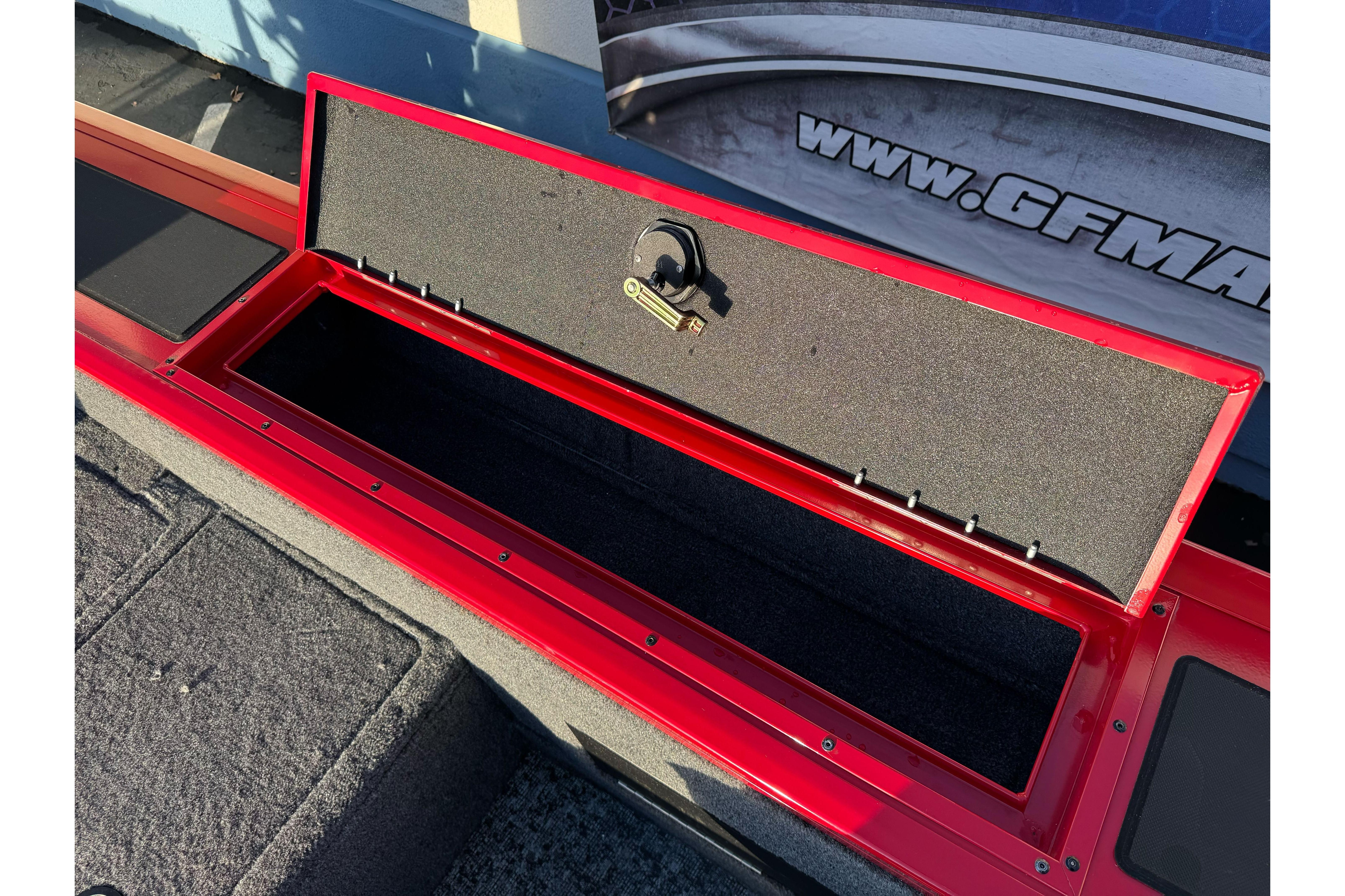 Open storage compartment on 2026 Tracker Targa V-18 WT boat, red finish.