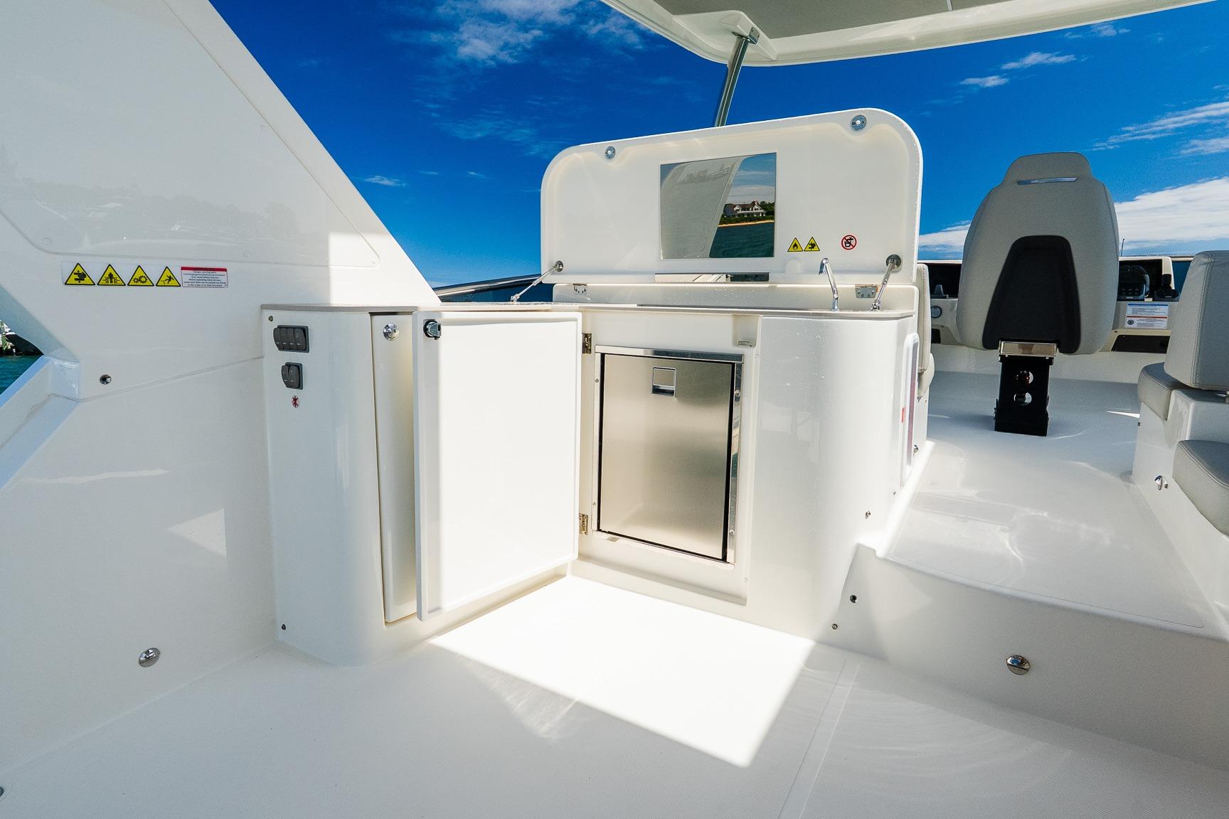 Luxury yacht Absolute Navetta 53, 2026 model, featuring sleek outdoor kitchen and seating area.