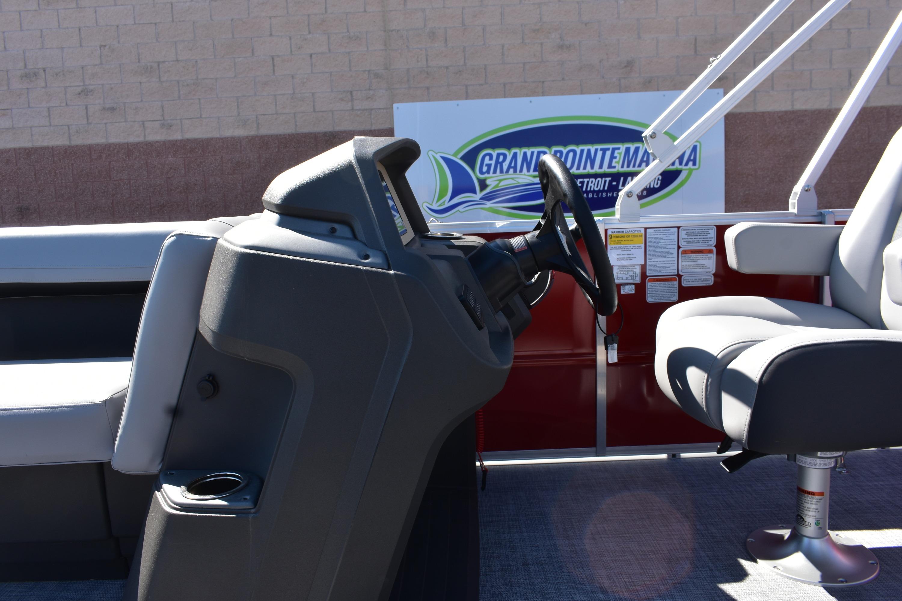 2026 Sun Tracker Party Barge 18 DLX interior with steering console and seating.