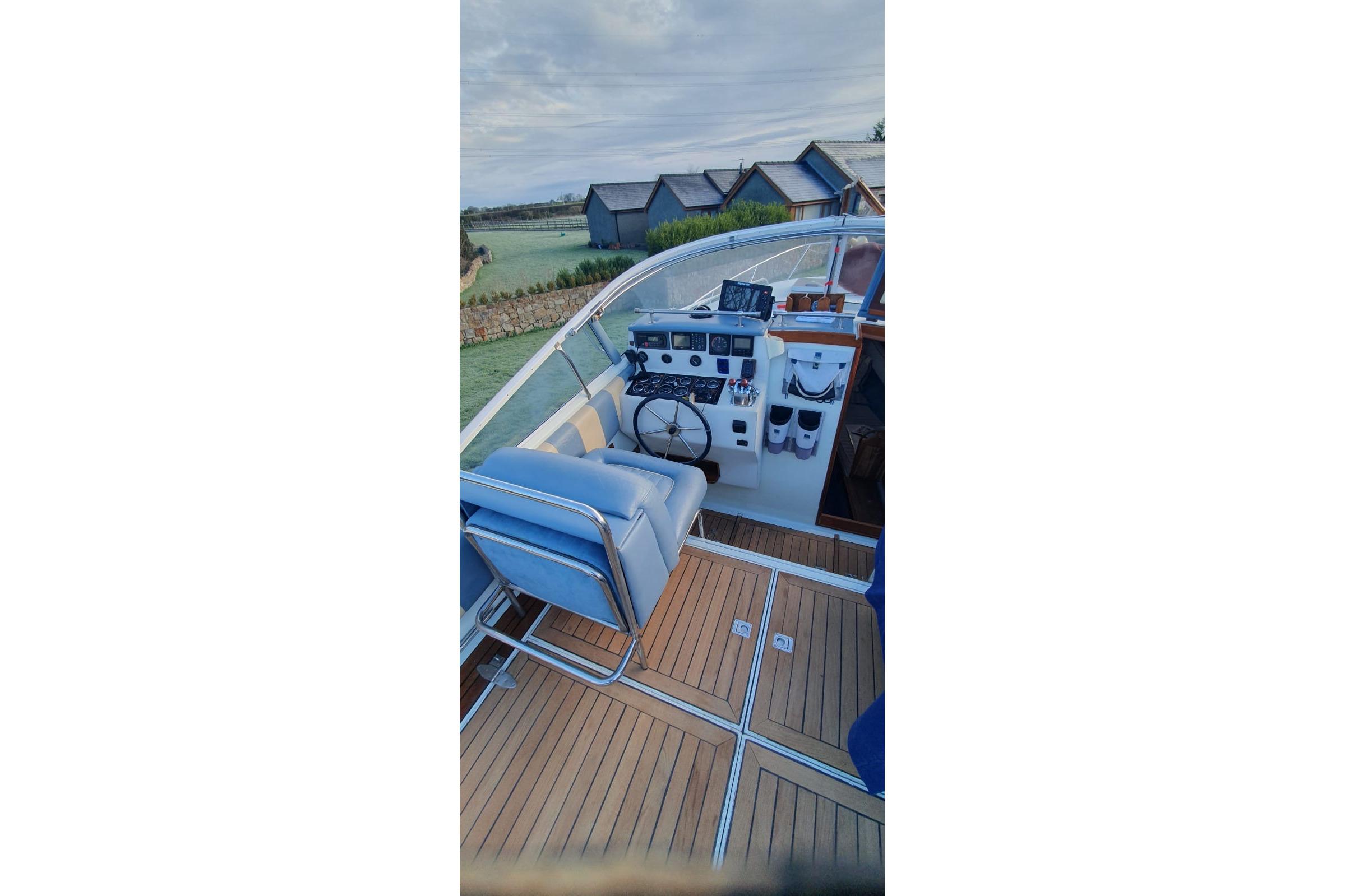 Cockpit of 1989 Fairey Spearfish MKIII boat with wooden deck and control panel.
